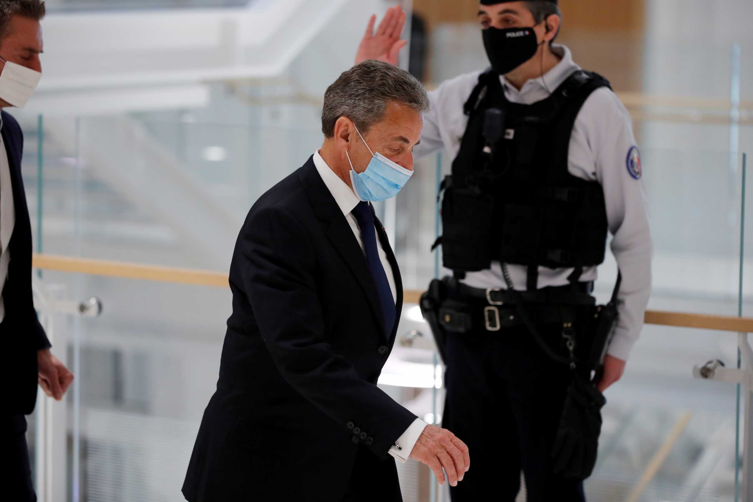 FILE PHOTO: Former French president Nicolas Sarkozy, wearing a protective face mask, leaves after the verdict in his trial on charges of corruption and influence peddling, at Paris courthouse, France, March 1, 2021. REUTERS