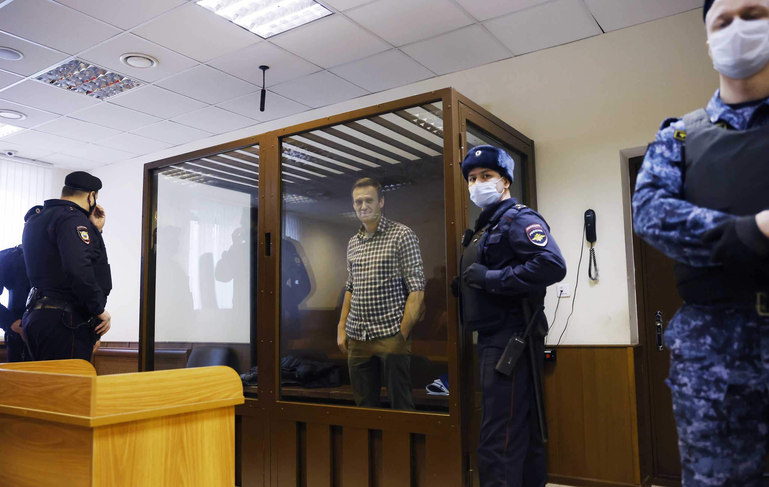 FILE PHOTO: Russian opposition leader Alexei Navalny attends a hearing to consider an appeal against an earlier court decision to change his suspended sentence to a real prison term, in Moscow, Russia February 20, 2021. REUTERS