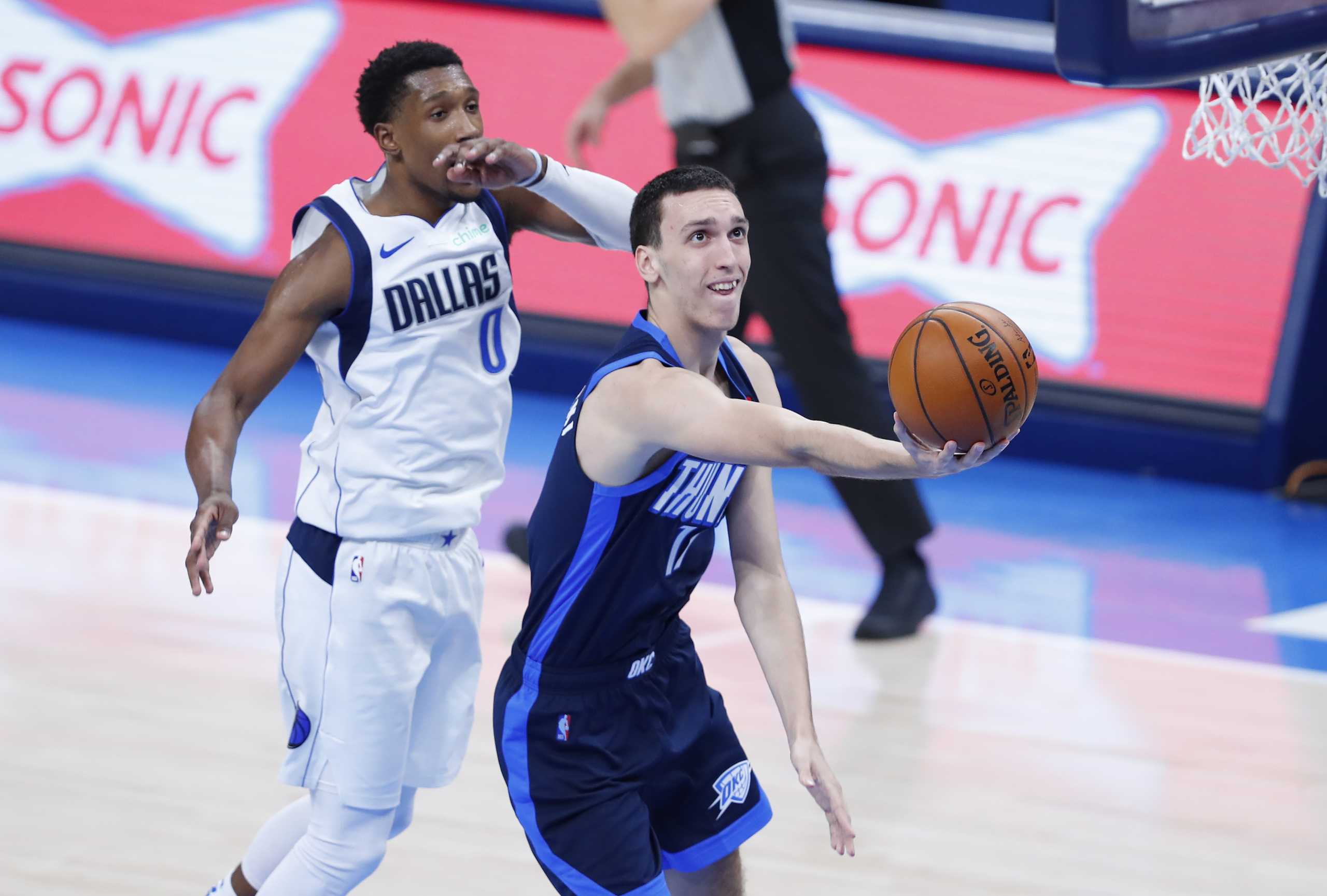 Mar 11, 2021; Oklahoma City, Oklahoma, USA; Oklahoma City Thunder forward Aleksej Pokusevski (17) drives to the basket against Dallas Mavericks guard Josh Richardson (0) during the second quarter at Chesapeake Energy Arena. Mandatory Credit: Alonzo Adams-USA TODAY Sports