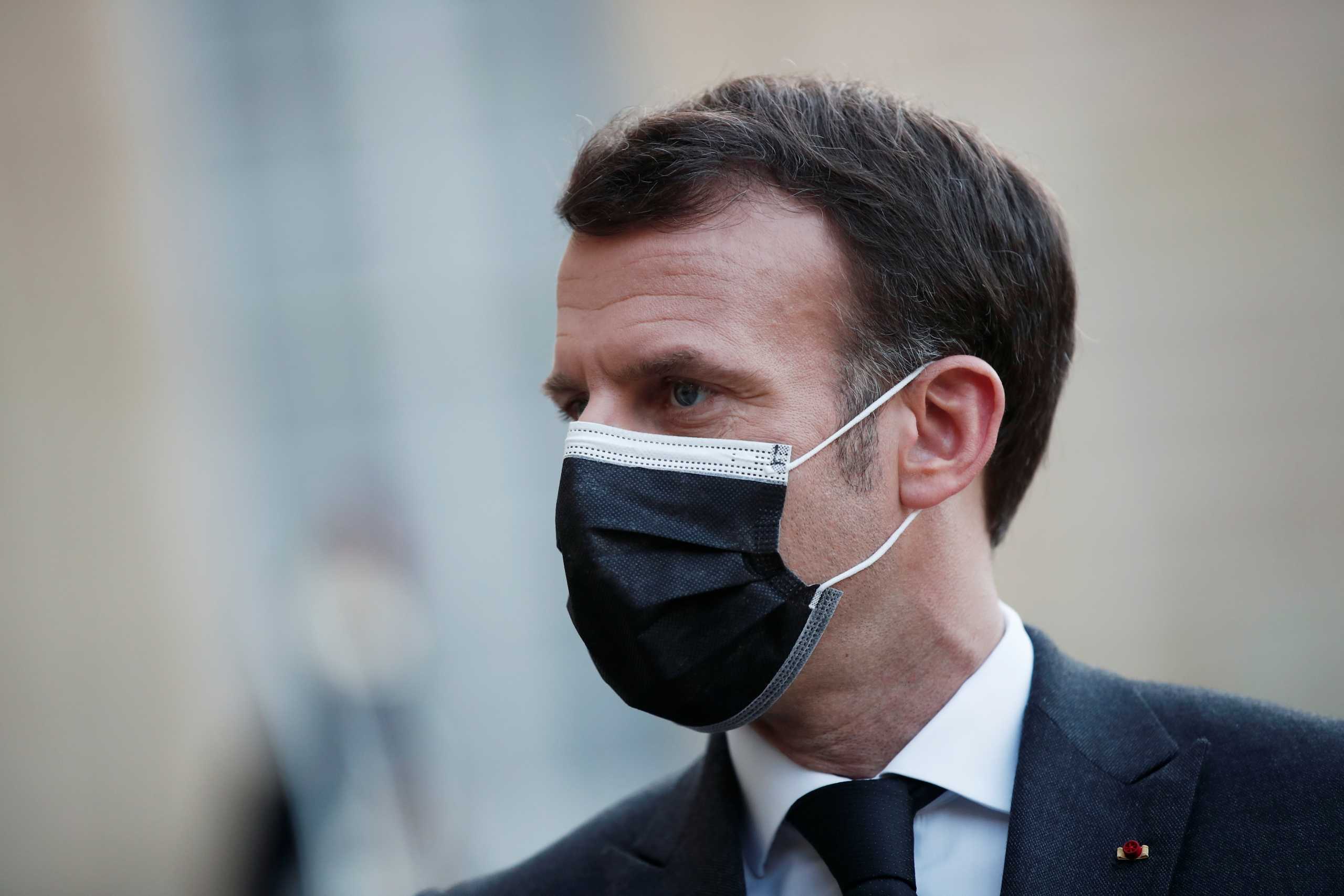 French President Emmanuel Macron, wearing a protective face mask, talks to the press after a meeting with Libya's interim leaders at the Elysee Palace in Paris, France, March 23, 2021. REUTERS