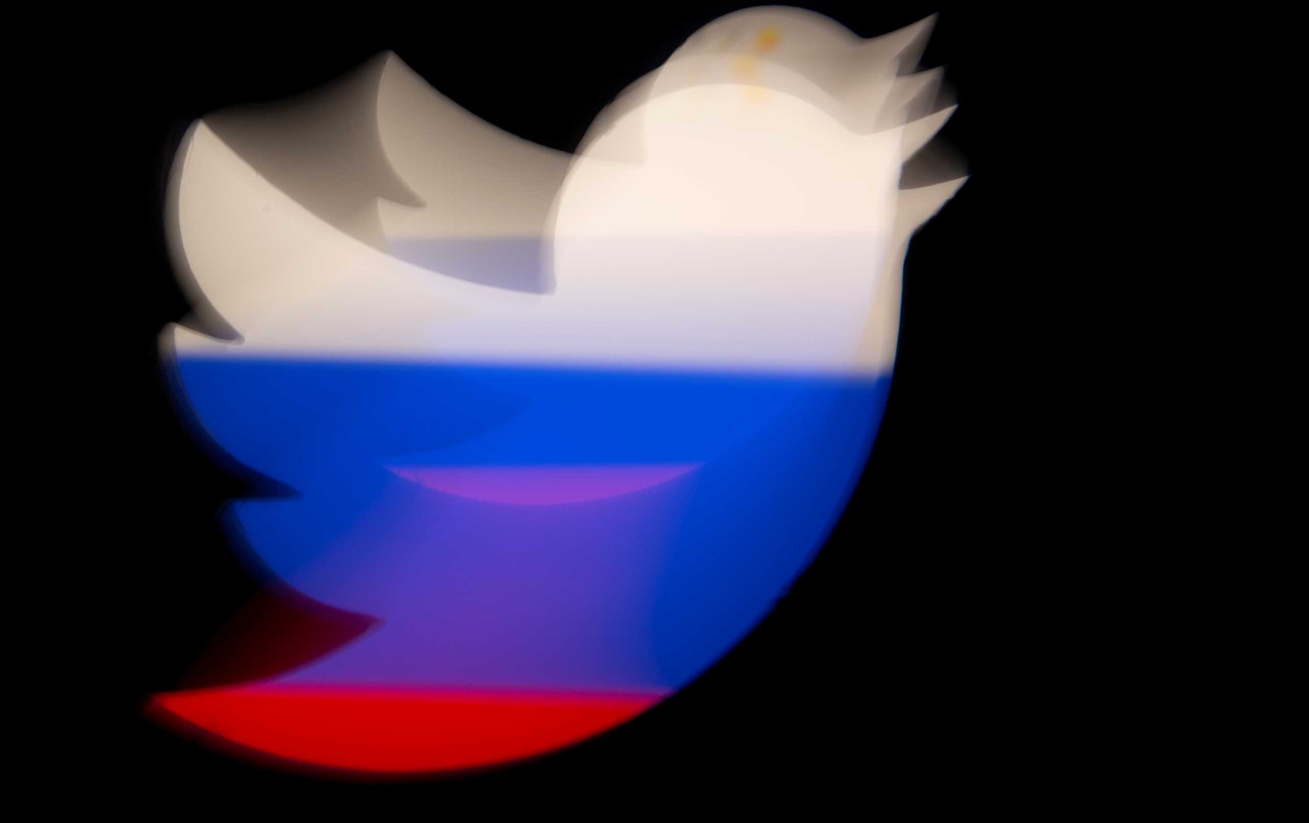 A 3d printed Twitter logo is pictured in front of a displayed Russian flag in this illustration taken March 10, 2021. REUTERS