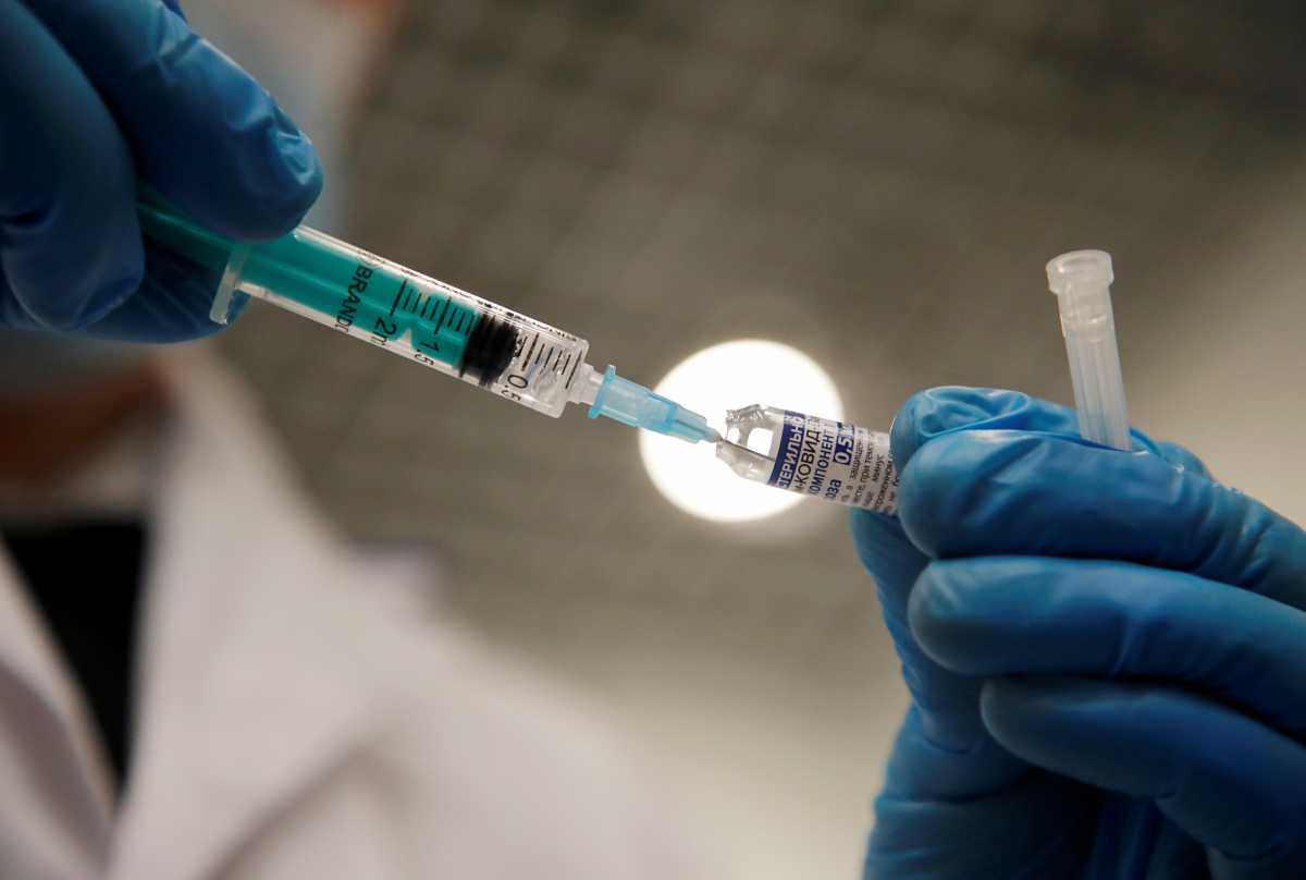 FILE PHOTO: A medical worker holds a syringe with Sputnik V vaccine against the coronavirus disease (COVID-19) at a vaccination centre in Saint Petersburg, Russia February 24, 2021. REUTERS