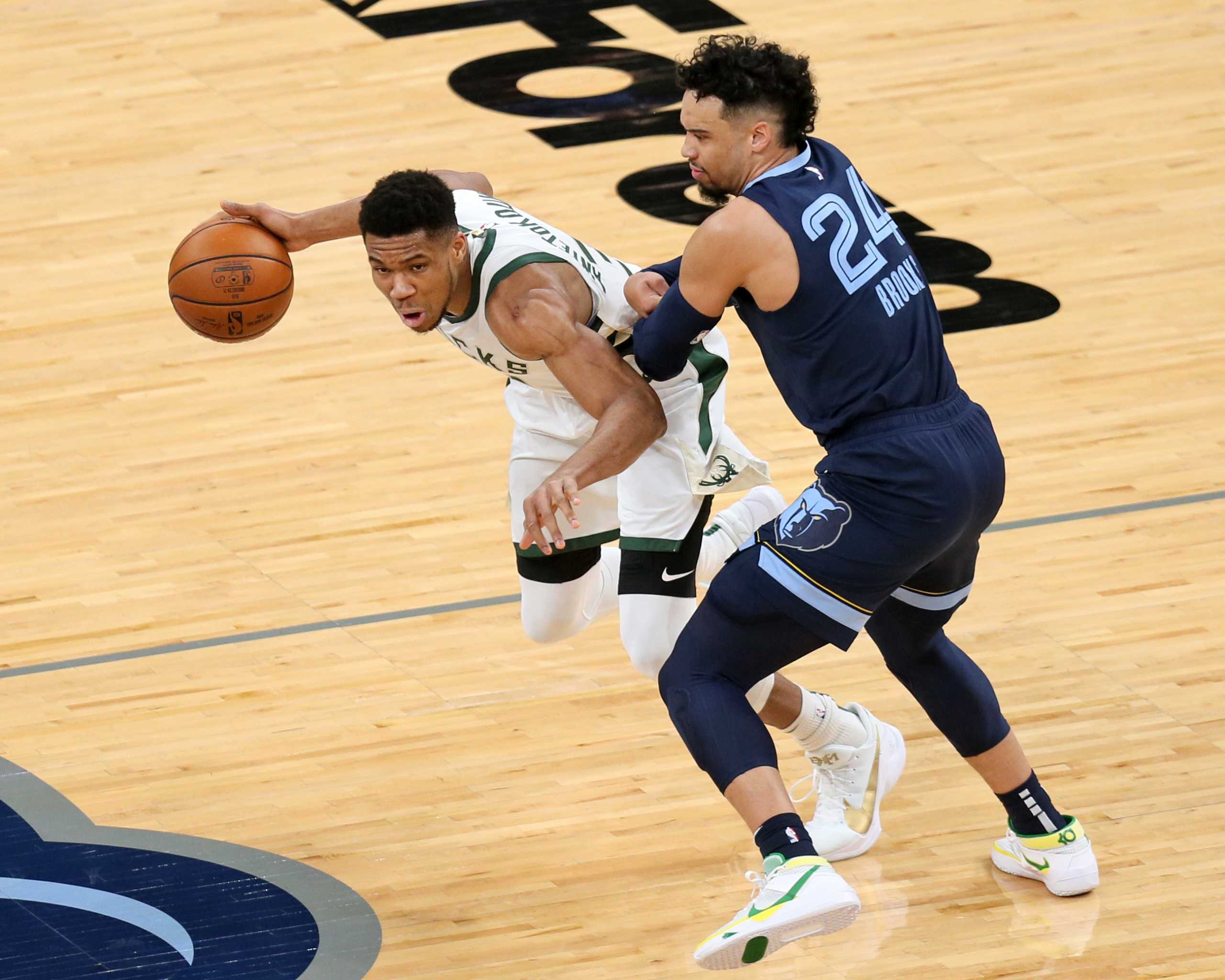 Mar 4, 2021; Memphis, Tennessee, USA; Milwaukee Bucks forward Giannis Antetokounmpo (34) drives against Memphis Grizzlies guard Dillon Brooks (24) in the first quarter at FedExForum. Mandatory Credit: Nelson Chenault-USA TODAY Sports