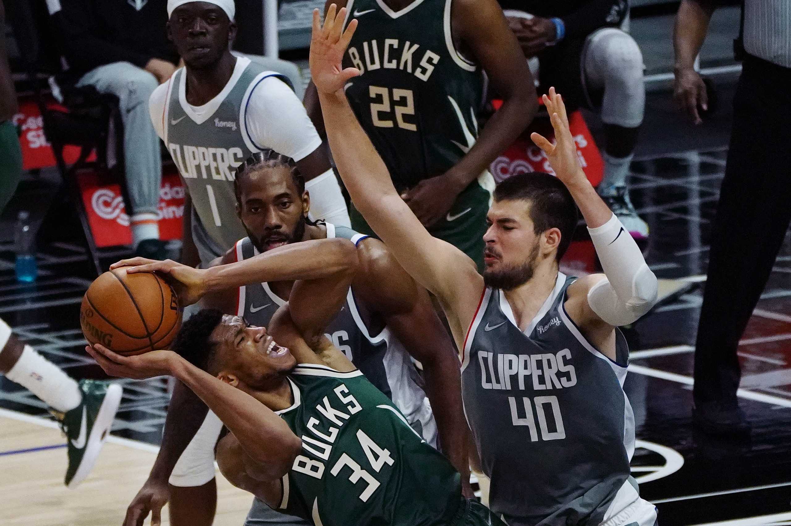 Mar 29, 2021; Los Angeles, California, USA; Milwaukee Bucks forward Giannis Antetokounmpo (34) moves to the basket against Los Angeles Clippers center Ivica Zubac (40) and forward Kawhi Leonard (2) during the second half at Staples Center. Mandatory Credit: Gary A. Vasquez-USA TODAY Sports