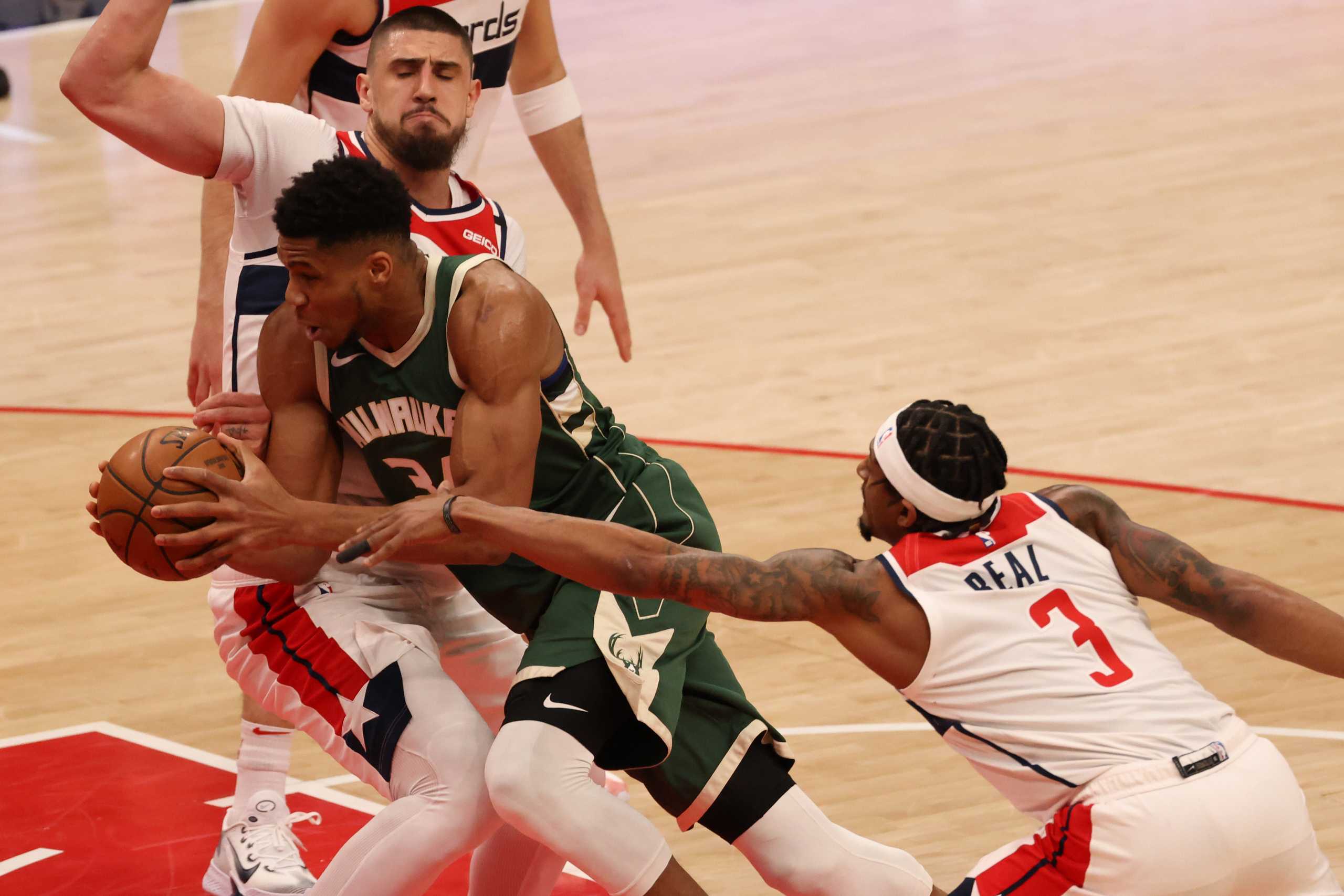 Mar 15, 2021; Washington, District of Columbia, USA; Milwaukee Bucks forward Giannis Antetokounmpo (34) drives to the basket as Washington Wizards guard Bradley Beal (3) and Wizards center Alex Len (27) defend in the first quarter at Capital One Arena. Mandatory Credit: Geoff Burke-USA TODAY Sports