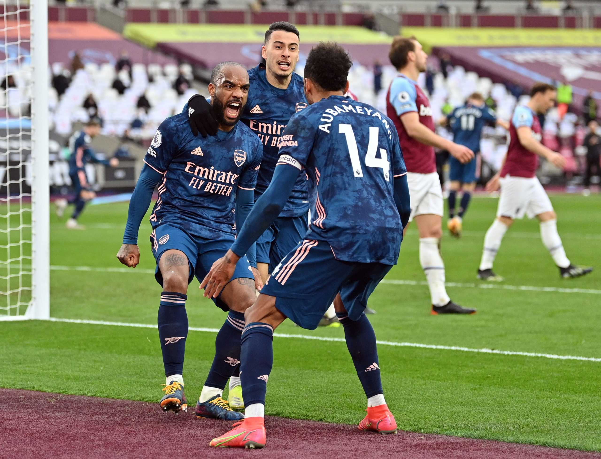 Soccer Football - Premier League - West Ham United v Arsenal  - London Stadium, London, Britain - March 21, 2021 Arsenal's Alexandre Lacazette celebrates scoring their third goal with teammate Pierre-Emerick Aubameyang Pool via REUTERS