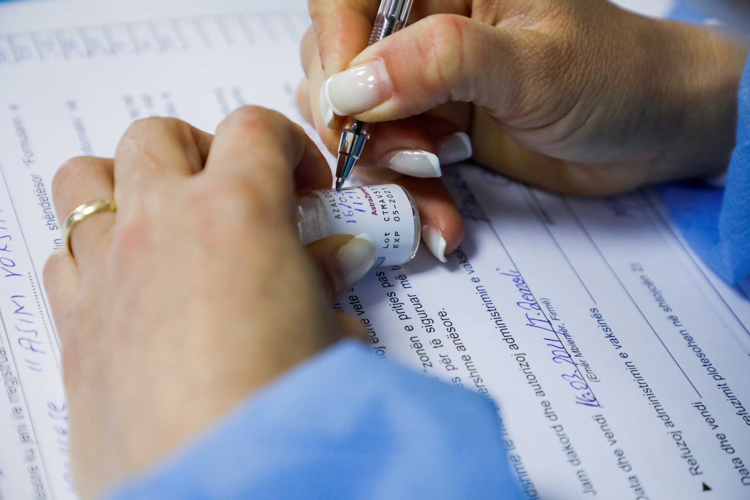 A health worker prepares a dose of the AstraZeneca coronavirus disease (COVID-19) vaccine, at "Ismail Qemali" high school, in Tirana, Albania, March 16, 2021. REUTERS