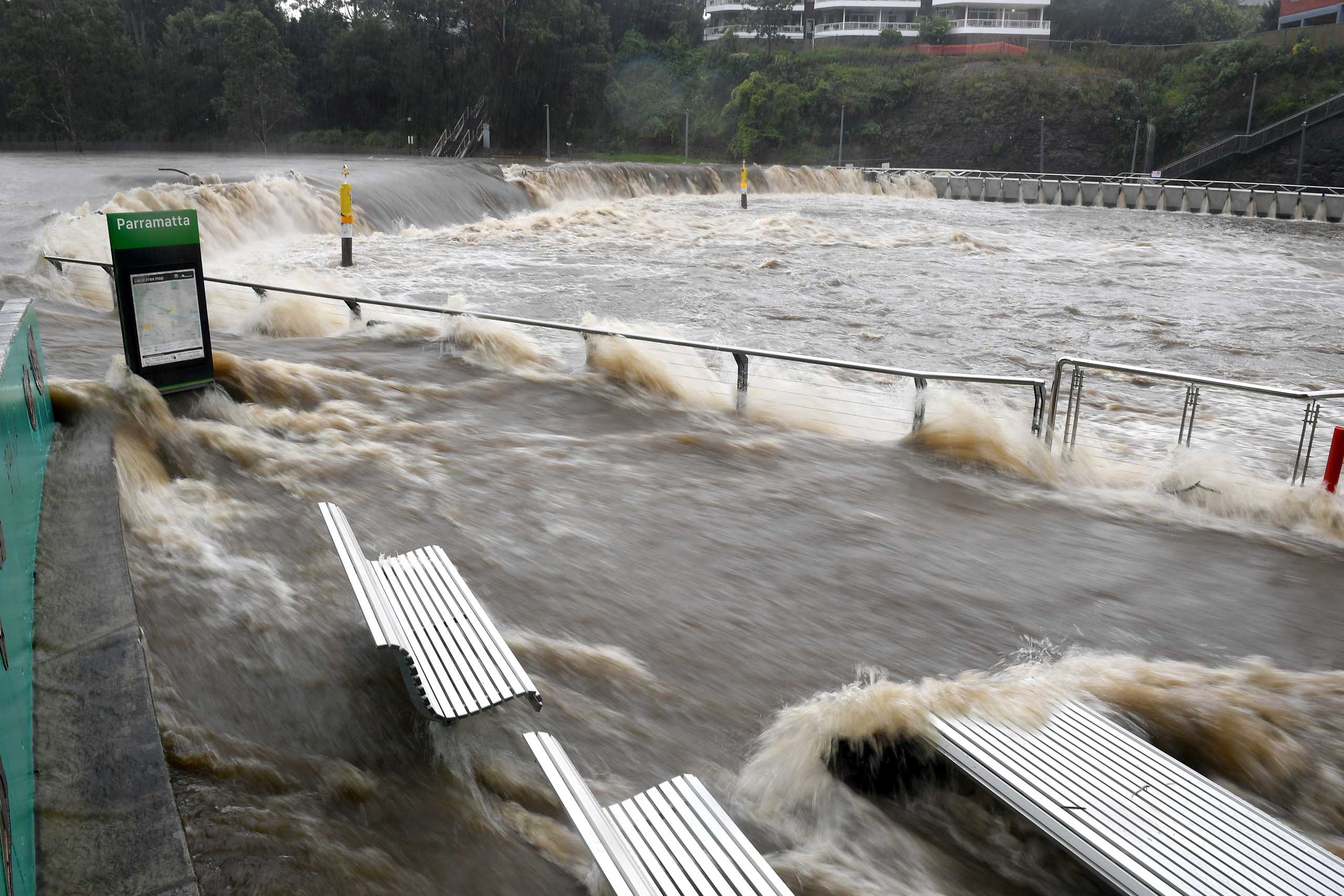 The swollen Parramatta River is seen overflowing as the state of New South Wales experiences heavy rains, in Sydney, Australia, March 20, 2021.  AAP Image