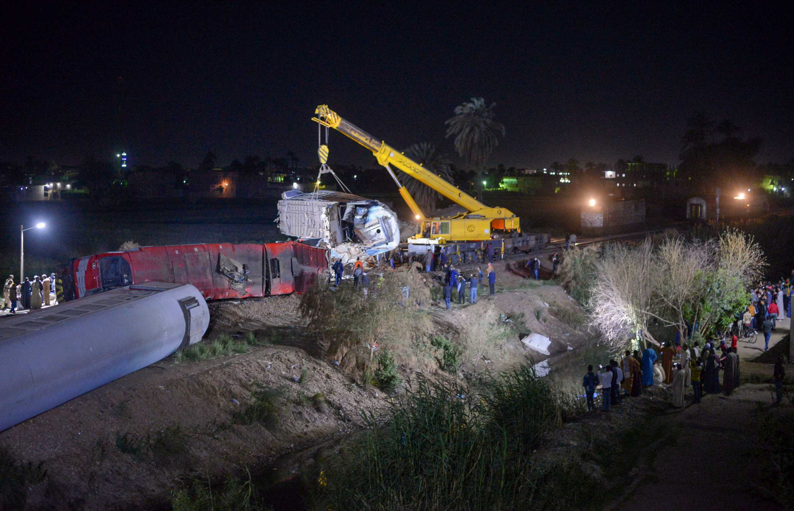 People inspect the damage after two trains have collided near the city of Sohag, Egypt, March 26, 2021. Picture taken March 26, 2021 REUTERS