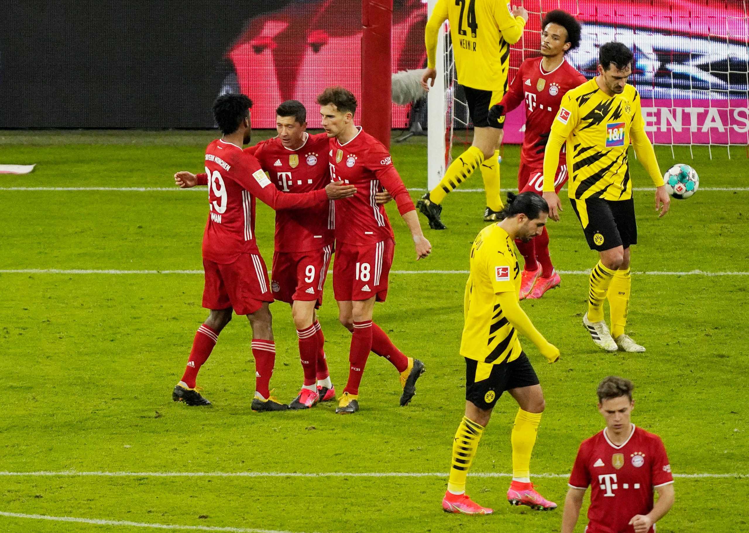 Soccer Football - Bundesliga - Bayern Munich v Borussia Dortmund - Allianz Arena, Munich, Germany - March 6, 2021 Bayern Munich's Robert Lewandowski celebrates scoring their second goal with Kingsley Coman and Leon Goretzka Pool via REUTERS