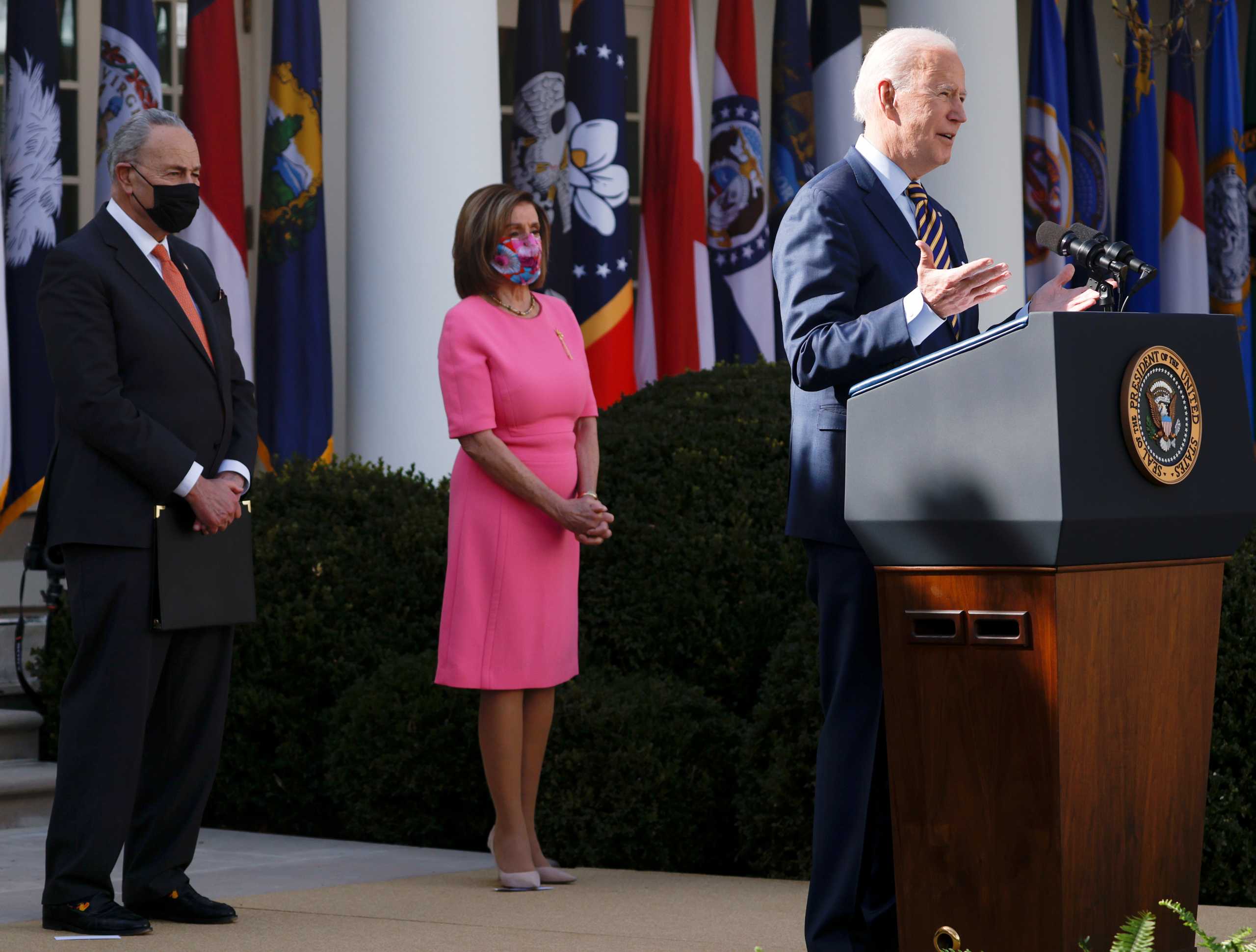 U.S. President Joe Biden speaks about the $1.9 trillion "American Rescue Plan Act" as House Speaker Nancy Pelosi (D-CA) and Senate Majority Leader Chuck Schumer (D-NY) listen during an event to celebrate the legislation in the Rose Garden at the White House in Washington, U.S., March 12, 2021. REUTERS