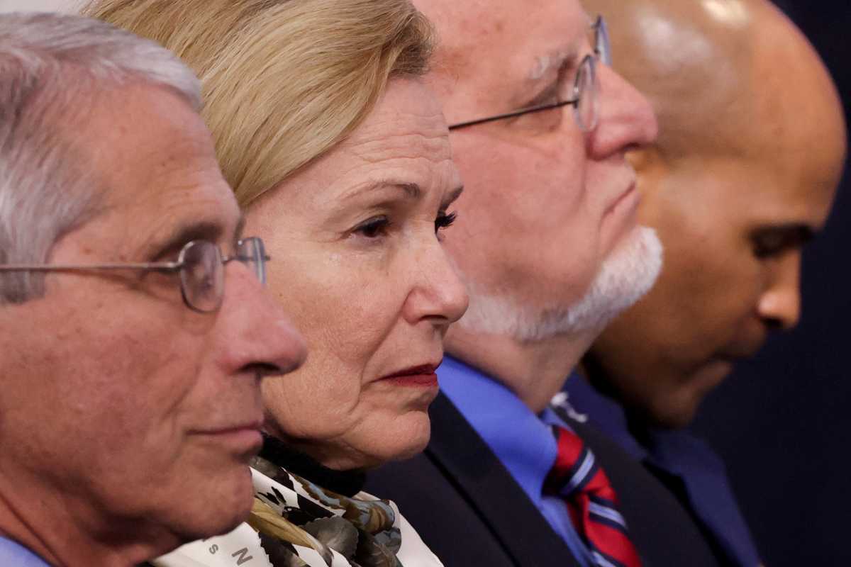 FILE PHOTO: White House coronavirus task force members, including Dr. Anthony Fauci of the National Institutes of Health, White House coronavirus coordinator Dr. Deborah Birx, Centers for Disease Control (CDC) Director Robert Redfield and U.S. Surgeon General Jerome Adams listen to President Donald Trump during the daily coronavirus disease (COVID-19) briefing at the White House in Washington, U.S., April 22, 2020. REUTERS