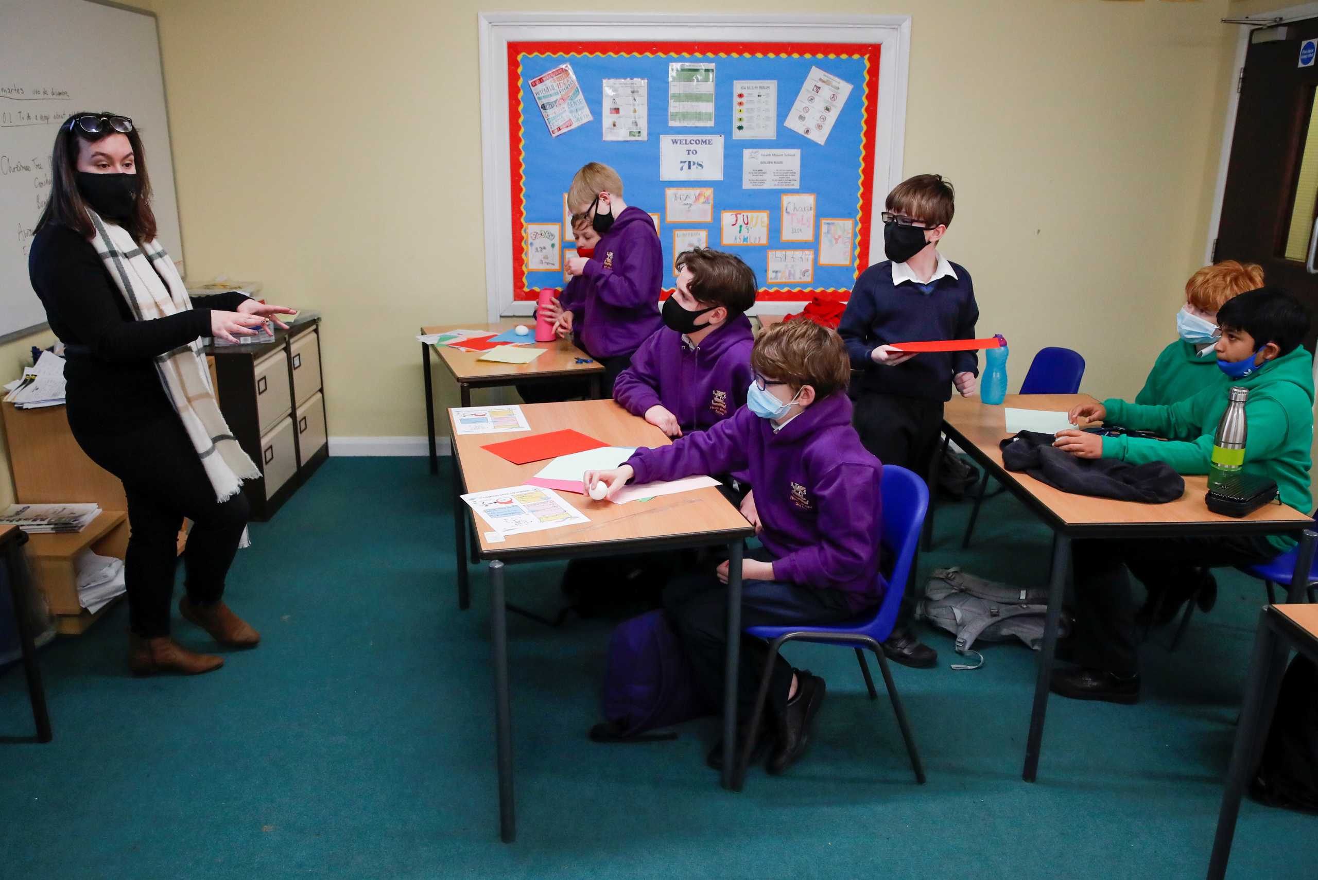 Students listen to a teacher during a lesson at Heath Mount school as schools reopen in England, amid the coronavirus disease (COVID-19) pandemic, in Watton at Stone, Hertfordshire, Britain March 8, 2021. REUTERS