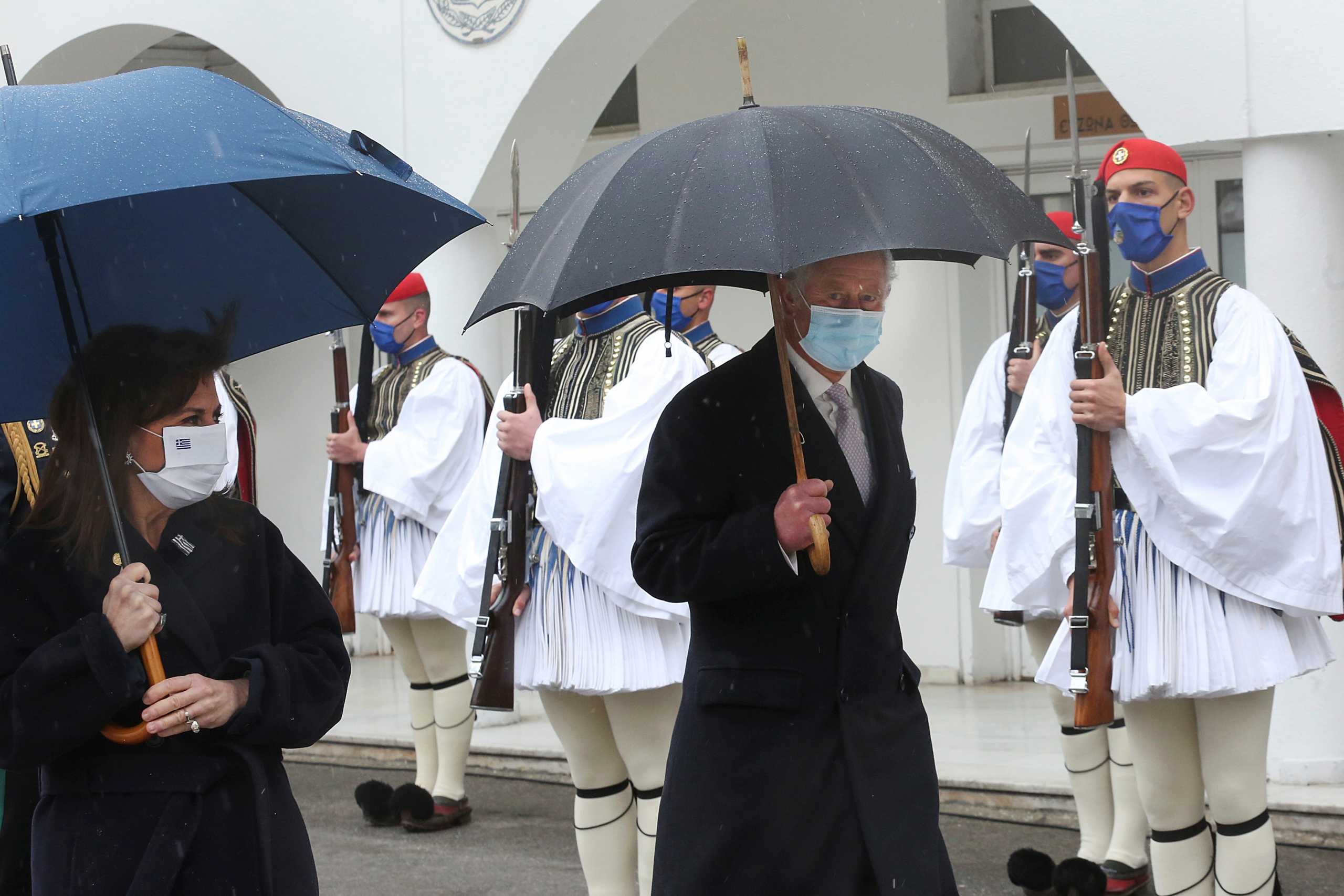 Greek President Katerina Sakellaropoulou and Britain's Prince Charles inspect the Greek Presidential Guards during celebrations for the 200th anniversary of the Greek War of Independence, following their meeting in Athens, Greece March 25, 2021. Orestis Panagiotou