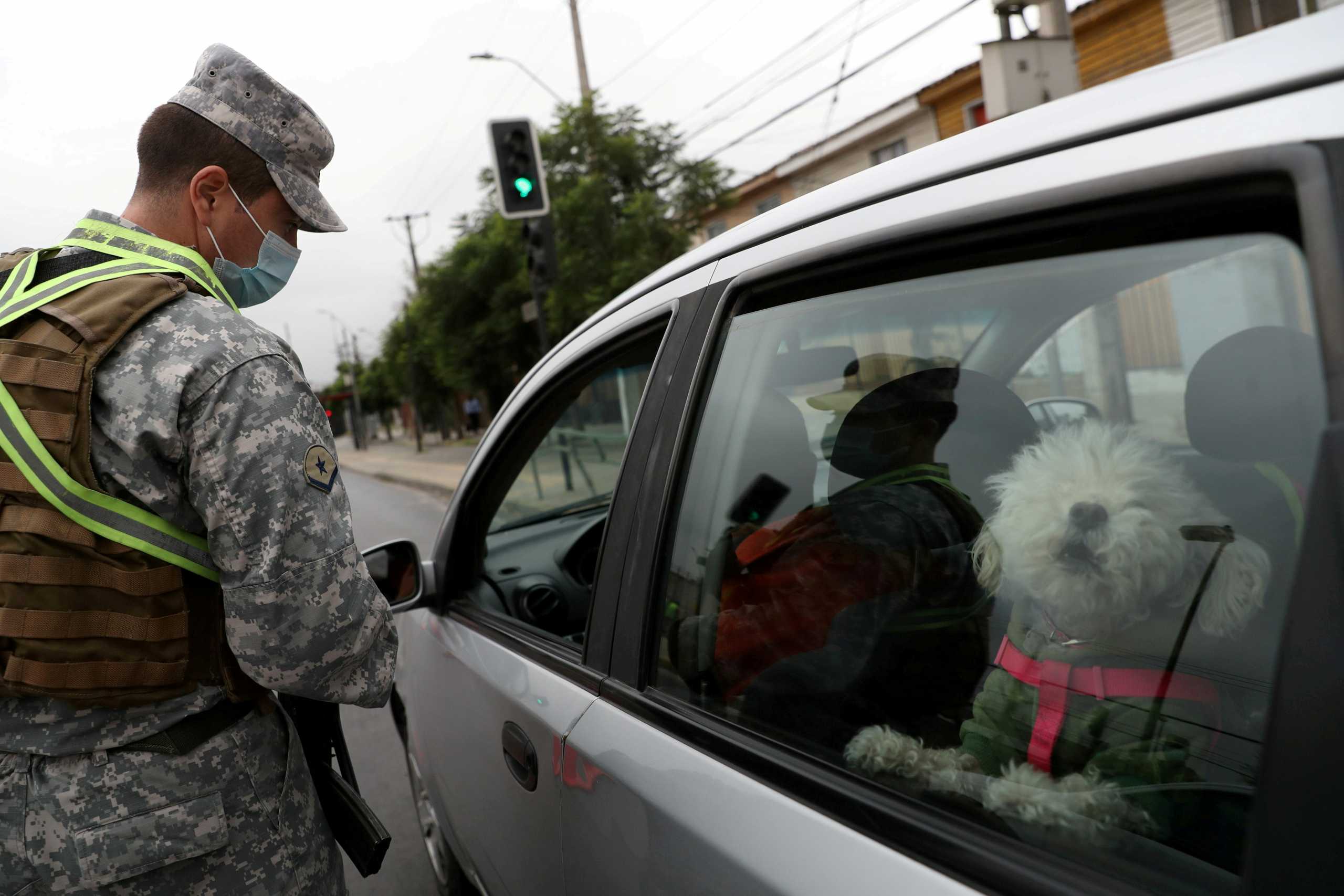 FILE PHOTO: A soldier checks a safeguard at a check point as local town halls have increased the lockdown restrictions during the coronavirus disease (COVID-19) outbreak, in Santiago, Chile, March 18, 2021. REUTERS