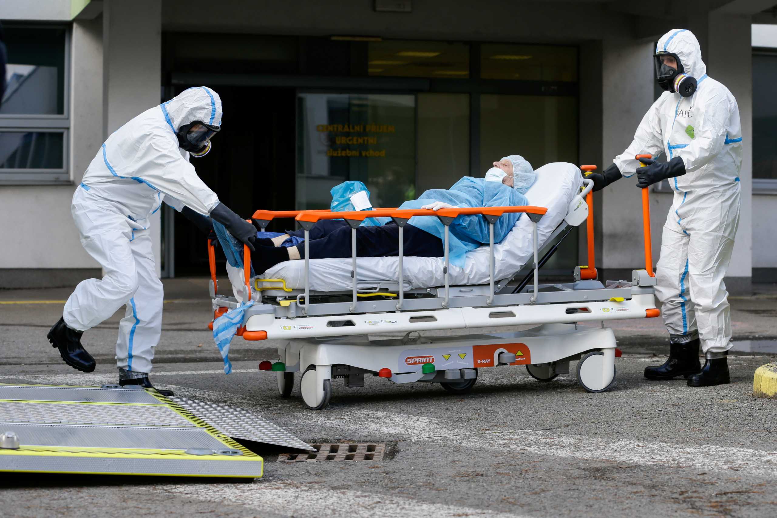 Prague Emergency Medical Services personnel push a patient on a hospital bed to a special ambulance truck from an overflowing hospital during the coronavirus disease (COVID-19) outbreak in Ceska Lipa, Czech Republic March 18, 2021. REUTERS