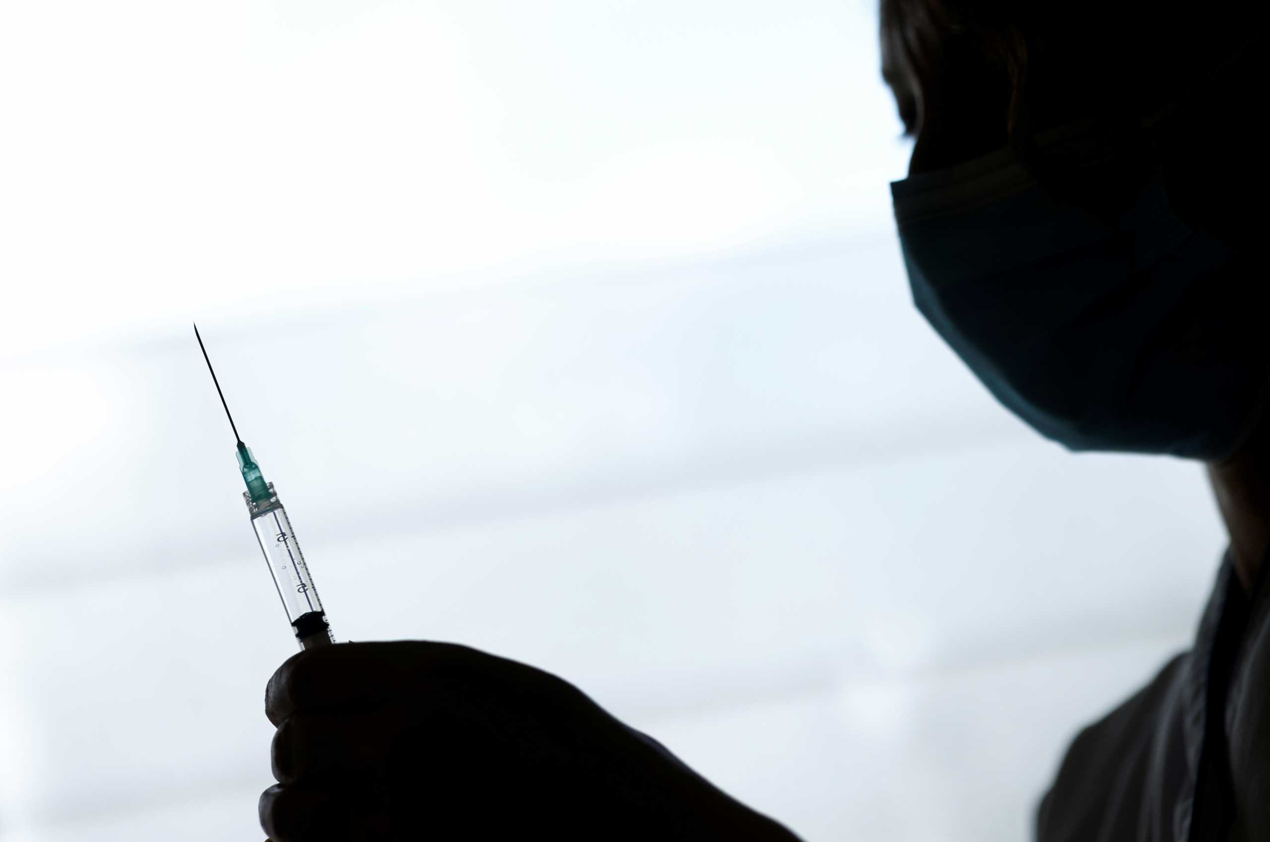 FILE PHOTO: A healthcare worker prepares a dose of the Pfizer-BioNTech COVID-19 vaccine in a vaccination center at the Confluent Hospital in Nantes, as part of the coronavirus disease (COVID-19) vaccination campaign in France, March 18, 2021. REUTERS