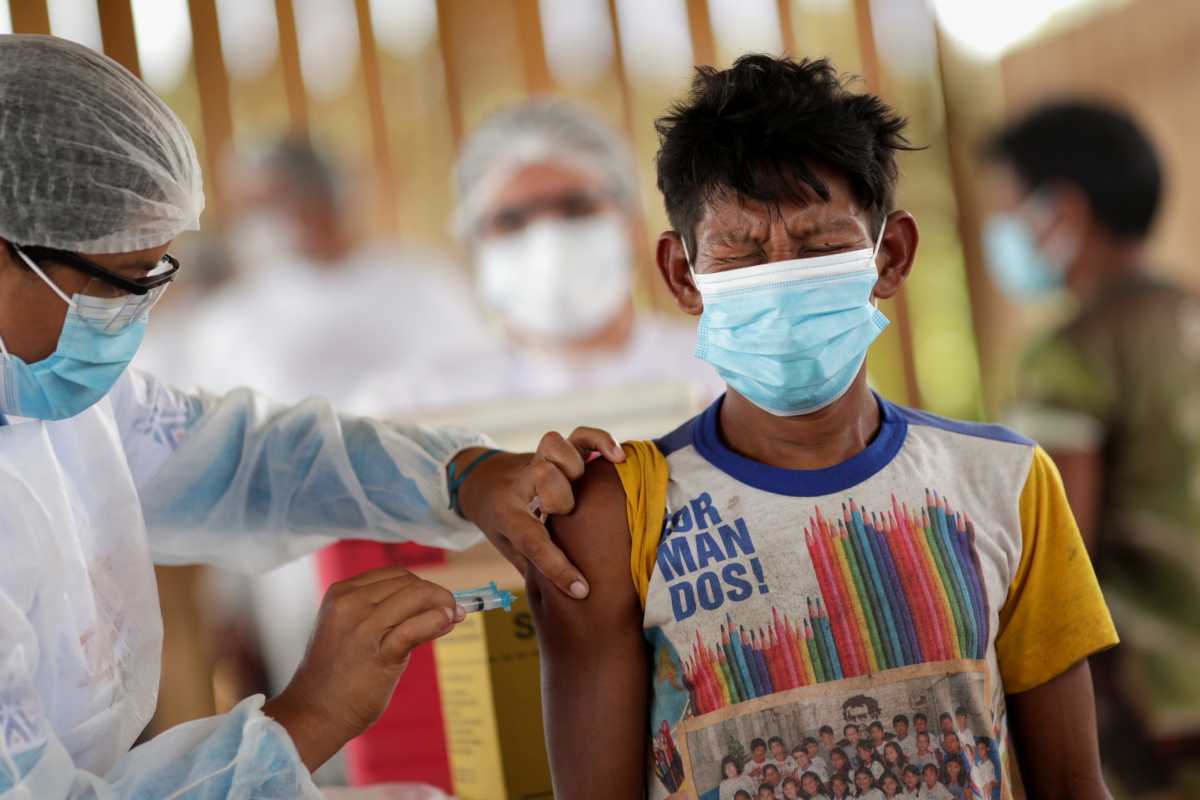 A man from the indigenous Hupda ethnic group receives a Sinovac's coronavirus disease (COVID-19) vaccine shot, at the indigenous village of Taracua Igarape, during an operation for vaccinating indigenous communities in the Upper Rio Negro bordering Colombia, near the village of Yauarete in the Sao Gabriel da Cachoeira district of Brazil's Amazonas state, Brazil, March 3, 2021. Picture taken March 3, 2021. REUTERS