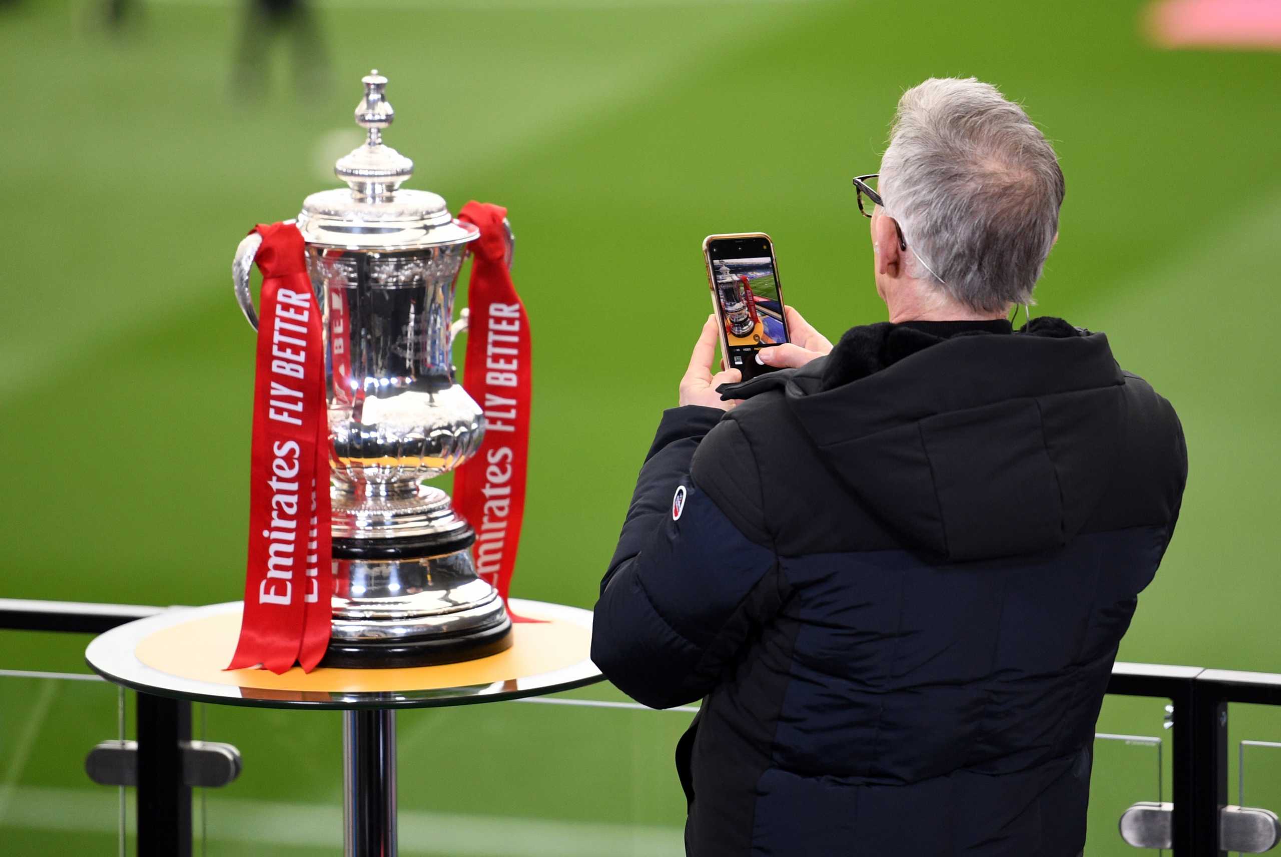 Soccer Football -  FA Cup Quarter Final - Leicester City v Manchester United - King Power Stadium, Leicester, Britain - March 21, 2021 Gary Lineker takes a picture of the FA Cup trophy before the match REUTERS