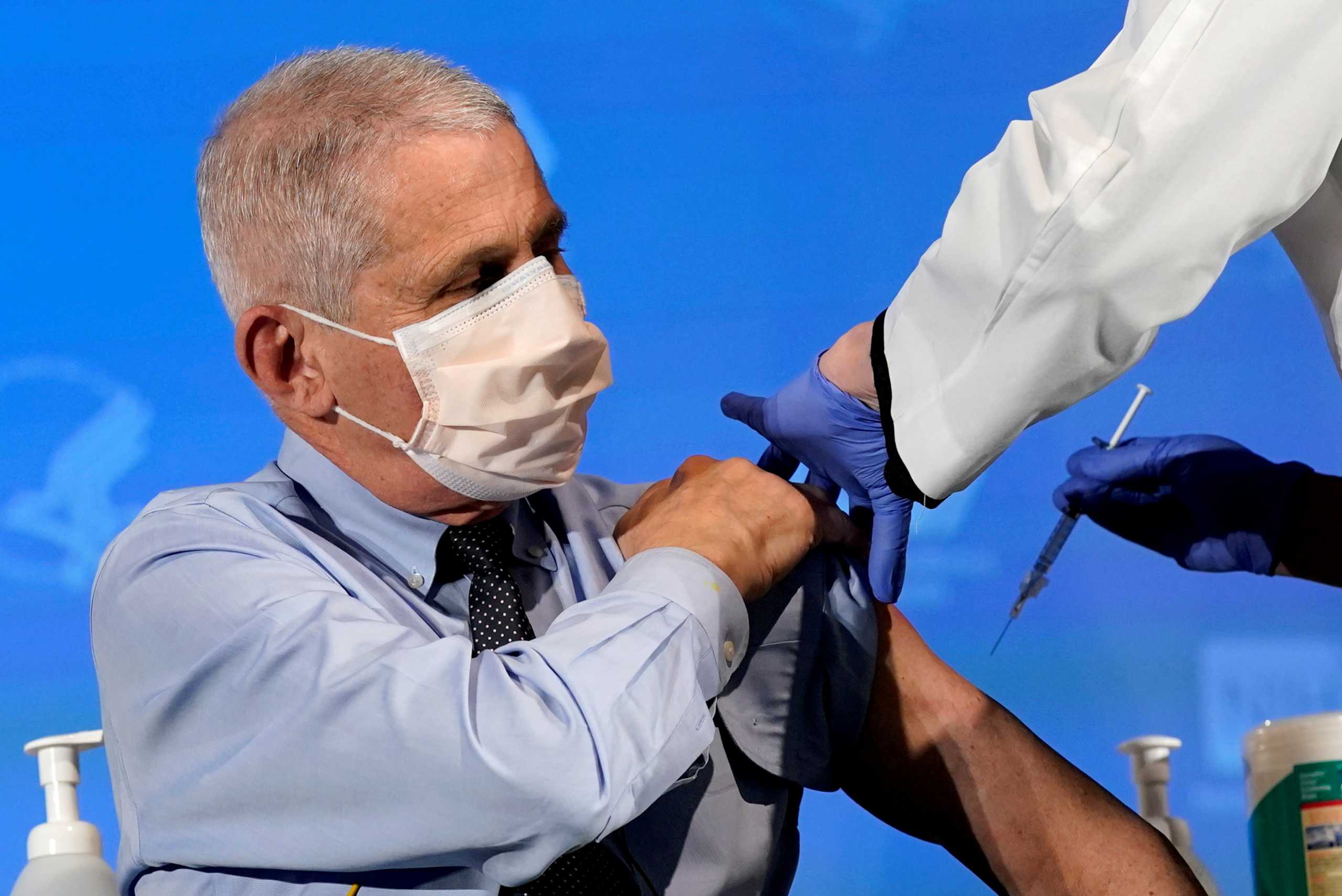 FILE PHOTO: Dr. Anthony Fauci, director of the National Institute of Allergy and Infectious Diseases, prepares to receive his first dose of the new Moderna COVID-19 vaccine at the National Institutes of Health, in Bethesda, U.S., December 22, 2020. Patrick Semansky