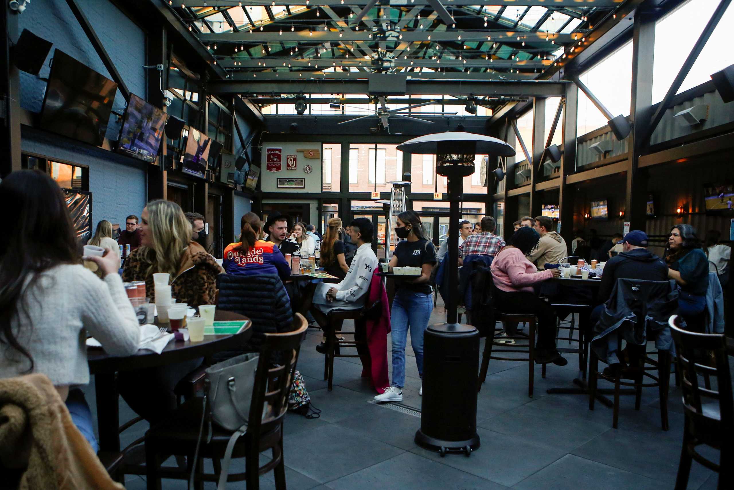 People drink at Rizzo's Bar & Inn in Wrigleyville as coronavirus disease (COVID-19) restrictions are relaxed in Chicago, Illinois, U.S., March 6, 2021. Picture taken March 6, 2021. REUTERS