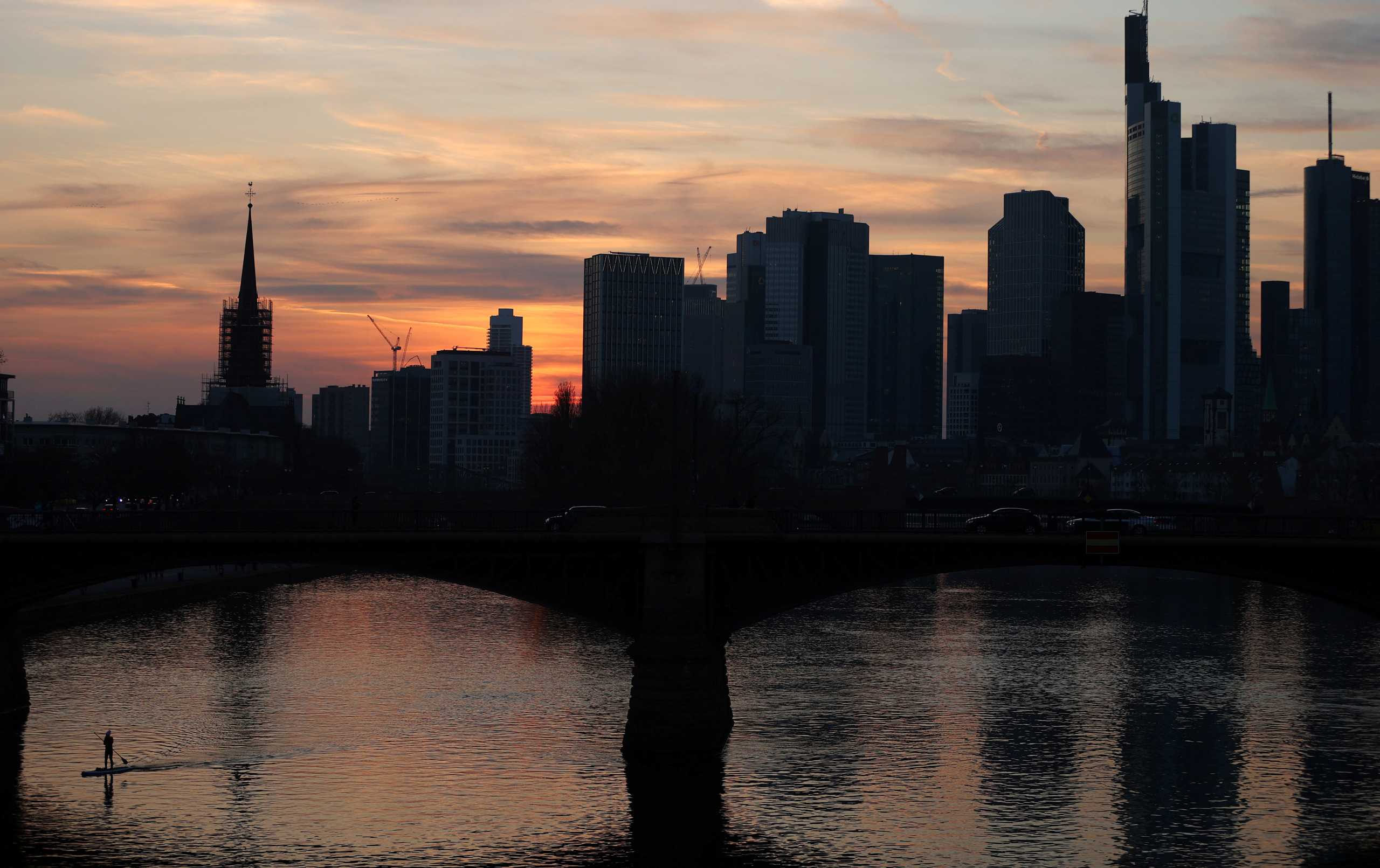 A stand-up paddler enjoys the first warm spring evening as the spread of the coronavirus disease (COVID-19) continues in Frankfurt, Germany, March 24, 2021.  REUTERS