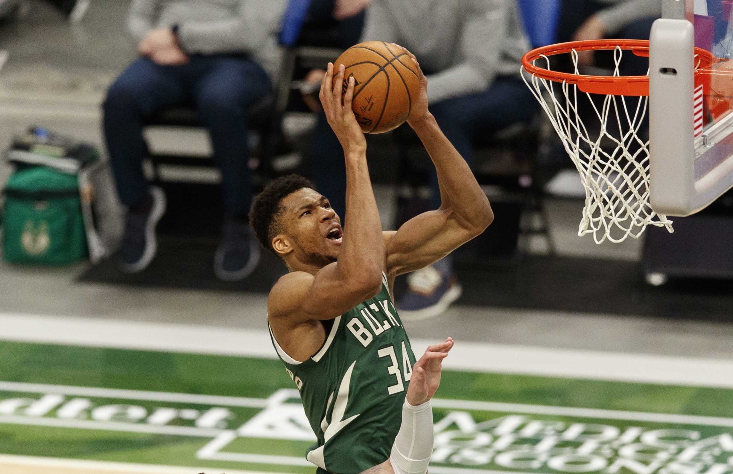 Mar 24, 2021; Milwaukee, Wisconsin, USA; Milwaukee Bucks forward Giannis Antetokounmpo (34) shoots over Boston Celtics center Daniel Theis (27) during the third quarter at Fiserv Forum. Mandatory Credit: Jeff Hanisch-USA TODAY Sports