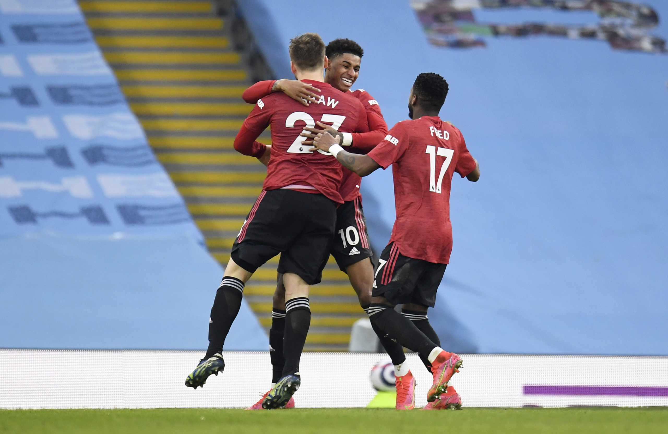 Soccer Football - Premier League - Manchester City v Manchester United - Etihad Stadium, Manchester, Britain - March 7, 2021 Manchester United's Luke Shaw celebrates scoring their second goal with Marcus Rashford Pool via REUTERS