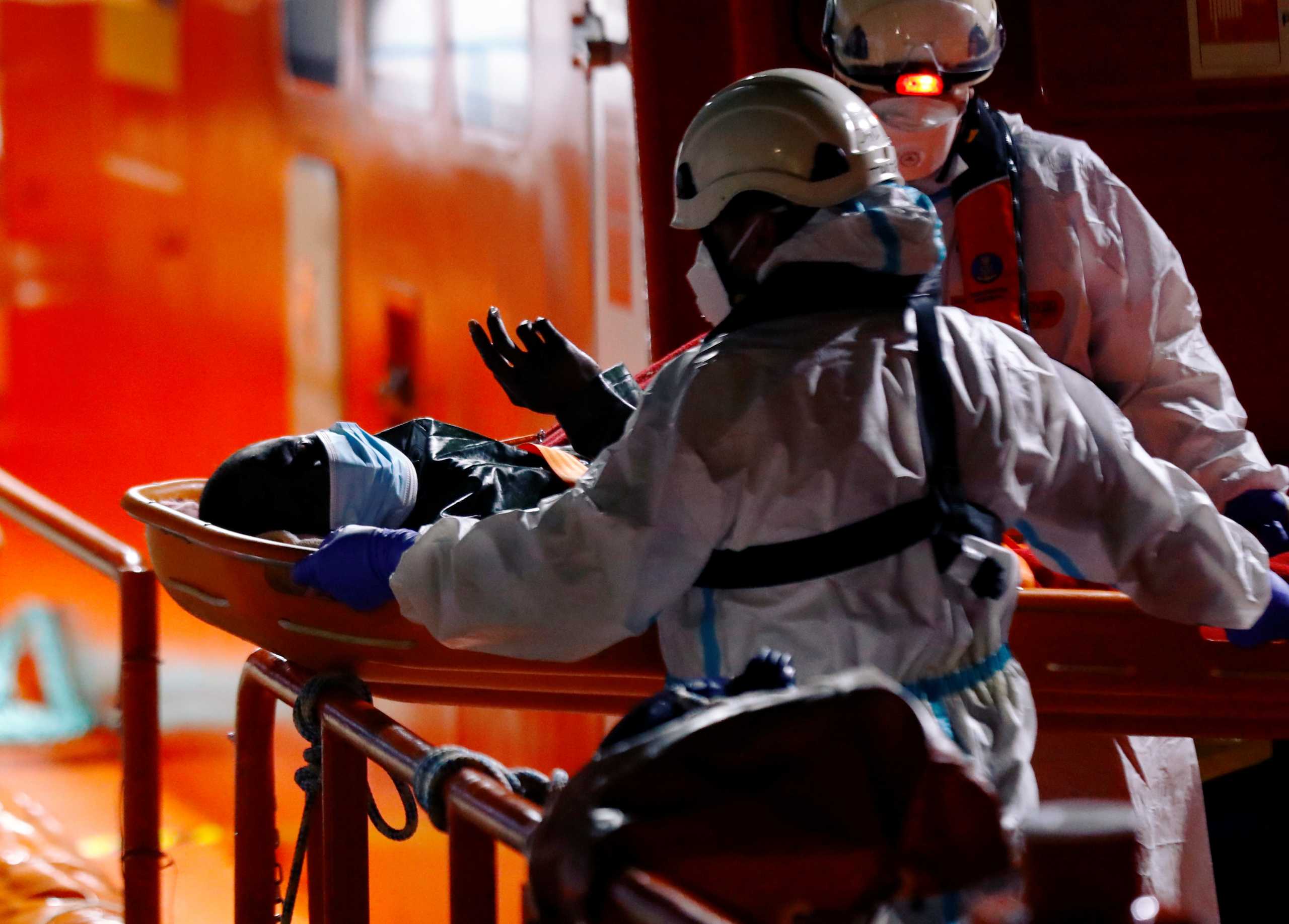 A migrant is disembarked from a Spanish coast guard vessel, in the port of Arguineguin, to the island of Gran Canaria, Spain March 9, 2021. REUTERS