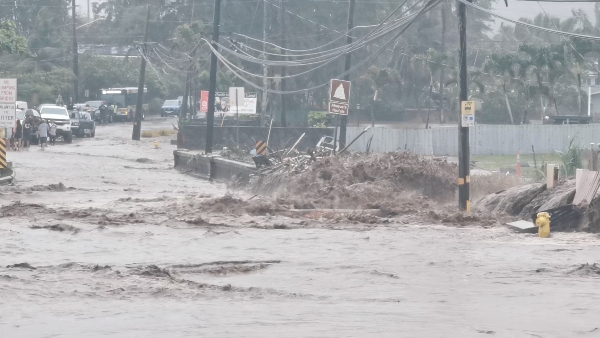 Floodwaters stream down a street in Hauula, Hawaii, U.S. March 9, 2021, in this still image obtained from a social media video. Courtesy of Adam Palmer