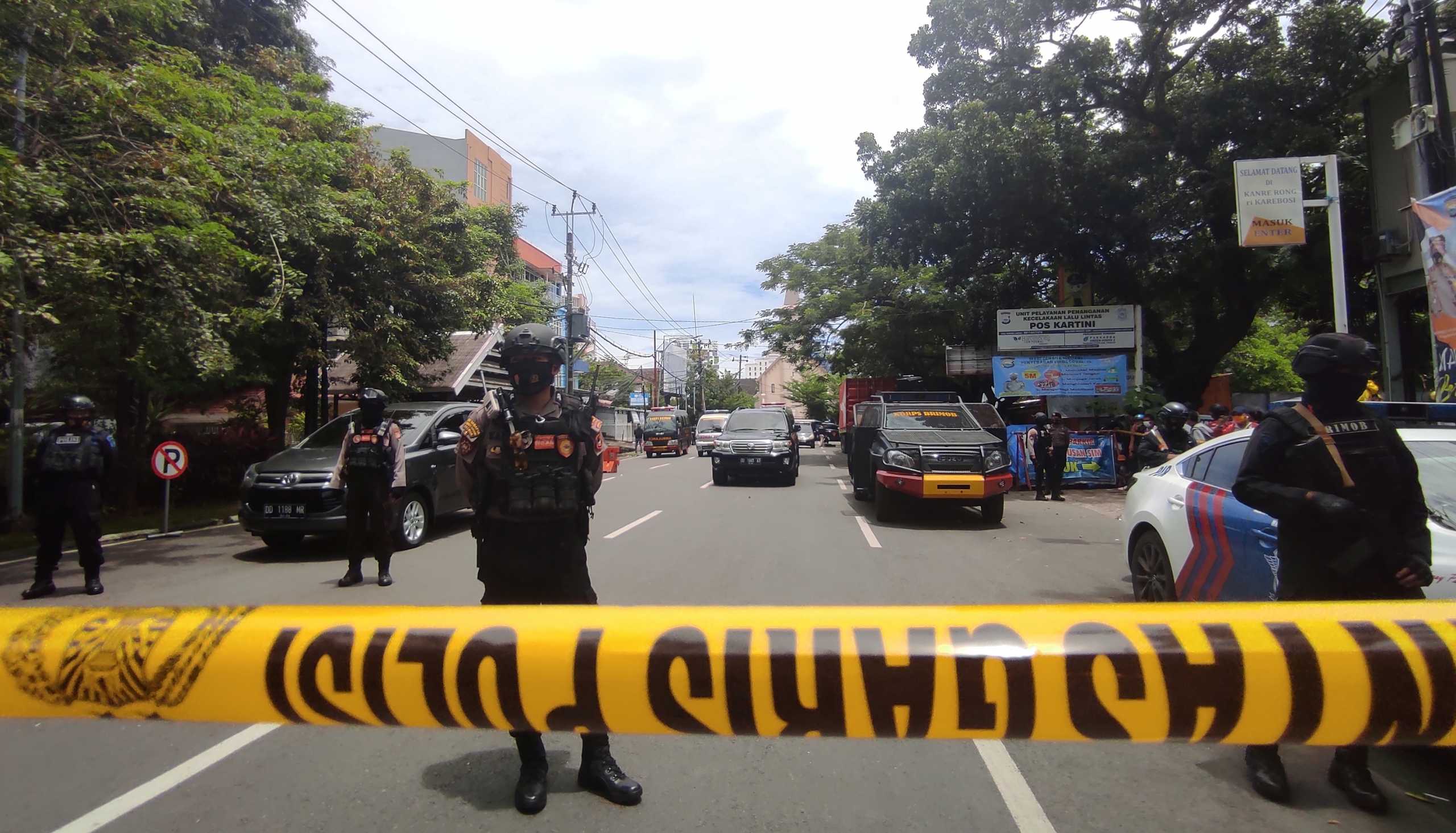 Armed police officers stand guard along a closed road following an explosion outside a Catholic church in Makassar, South Sulawesi province, Indonesia, March 28, 2021. REUTERS