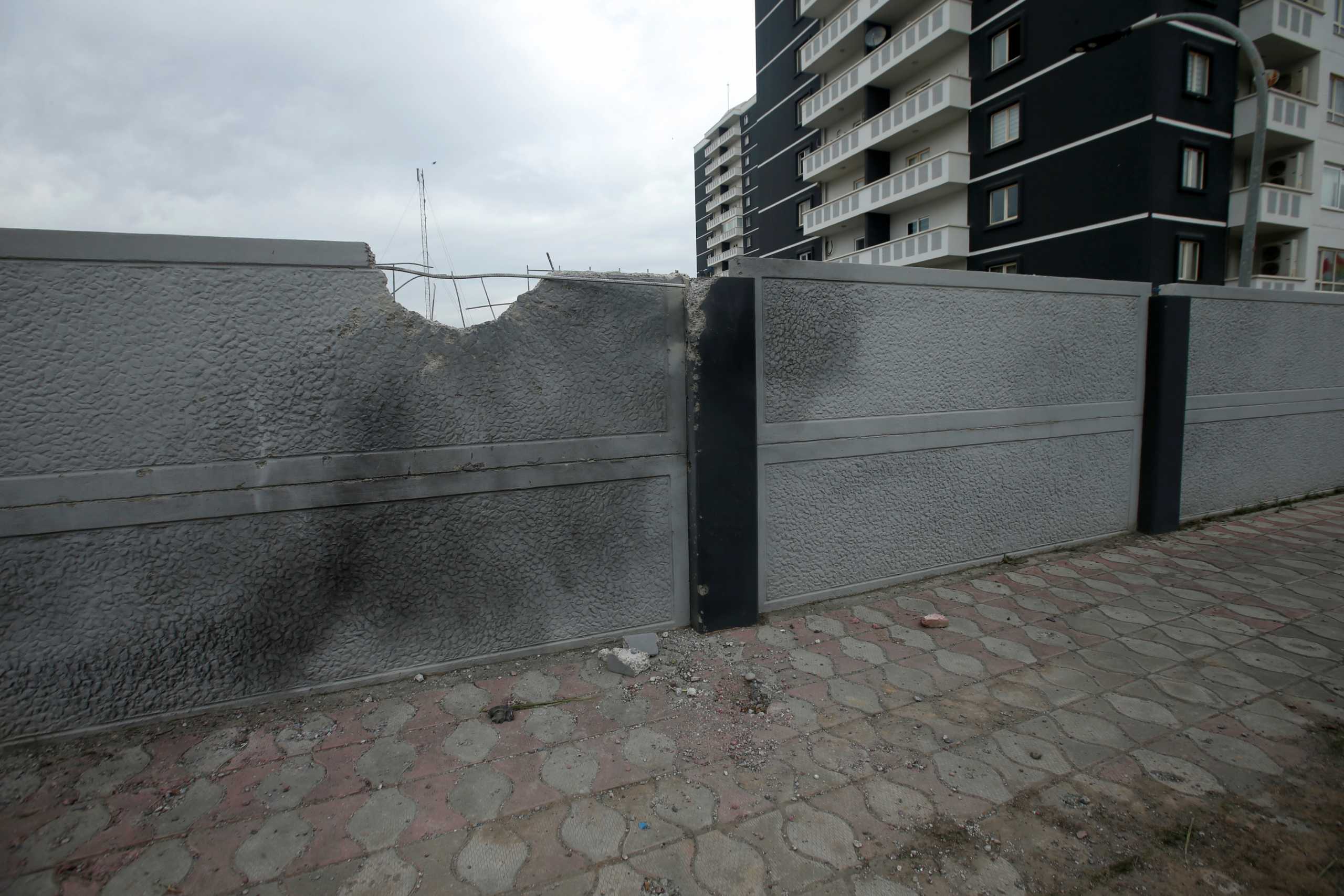 A damaged wall is seen after last night's rocket attack on U.S.-led forces in and near Erbil International Airport, in Erbil, Iraq February 16, 2021. REUTERS