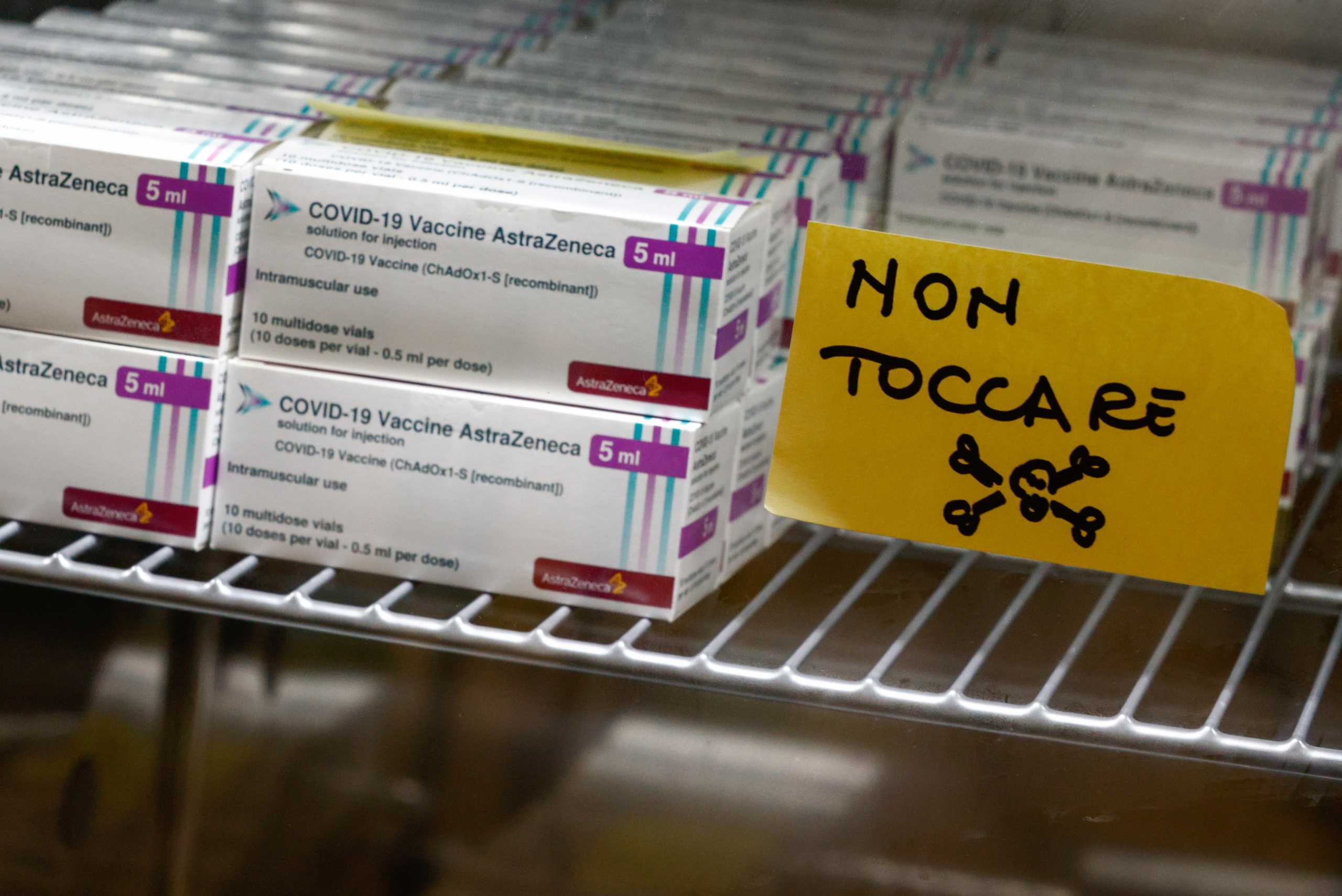 Boxes containing vials of the AstraZeneca vaccine are stored inside a fridge during the coronavirus disease (COVID-19) vaccination campaign, as the country sees a surge in the number of infections, in Rome, Italy, March 5, 2021. The sticker reads "Don't touch". REUTERS