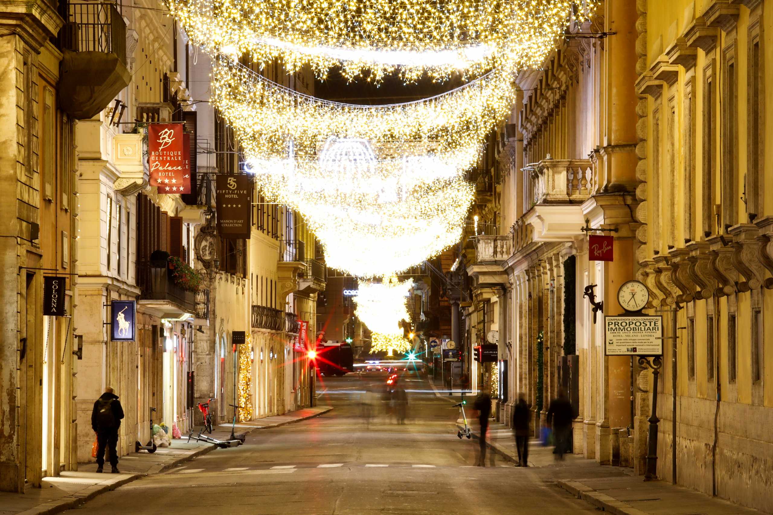 FILE PHOTO: People walk by an almost deserted Via del Corso as Italy goes back to a complete lockdown during Christmas season as part of efforts put in place to curb the spread of the coronavirus disease (COVID-19) in Rome, Italy, December 24, 2020. REUTERS