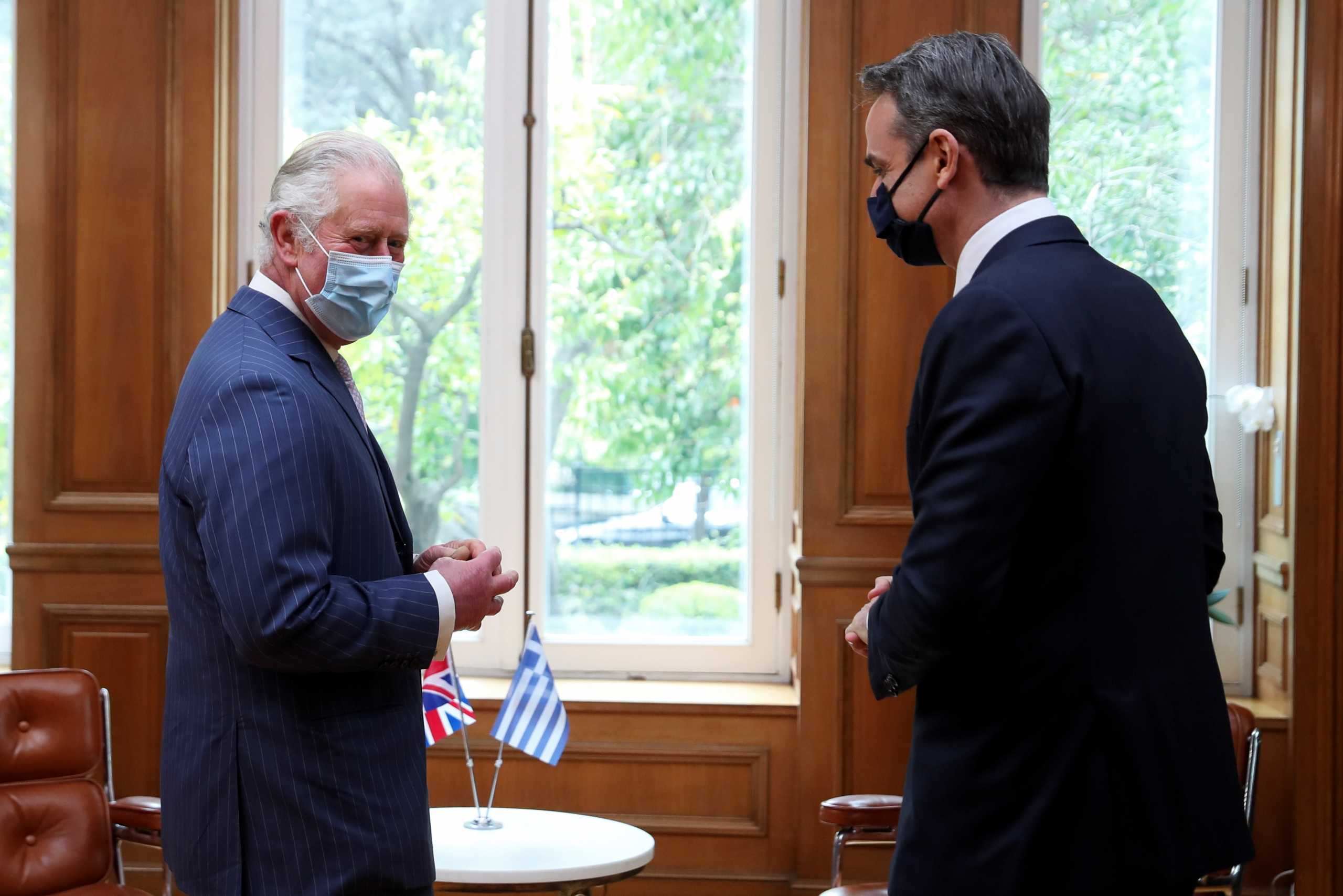 Greek Prime Minister Kyriakos Mitsotakis meets with Britain's Prince Charles at the Maximos Mansion during celebrations for the 200th anniversary of the Greek War of Independence, in Athens, Greece, March 25, 2021. REUTERS