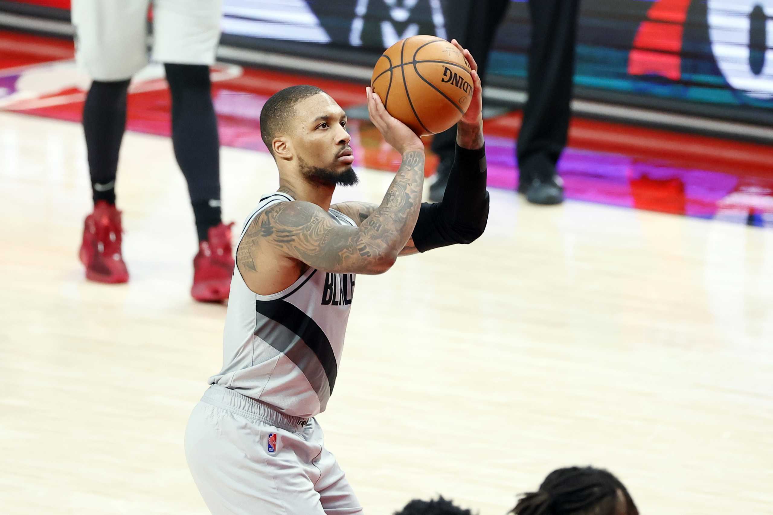 Mar 16, 2021; Portland, Oregon, USA; Portland Trail Blazers point guard Damian Lillard (0) prepares to shoot a free throw during the second half against the New Orleans Pelicans at Moda Center. Mandatory Credit: Soobum Im-USA TODAY Sports