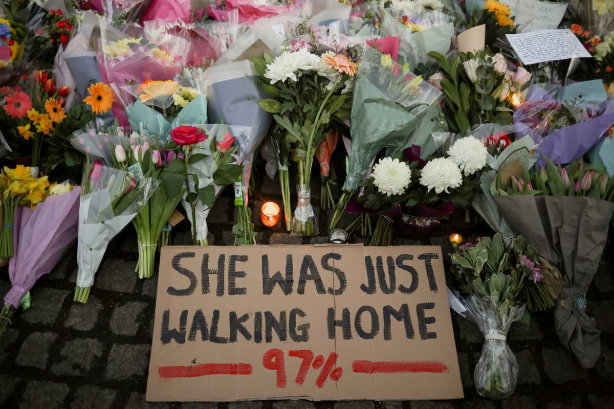 A sign is seen as people gather at a memorial site in Clapham Common Bandstand, following the kidnap and murder of Sarah Everard, in London, Britain March 13, 2021. REUTERS