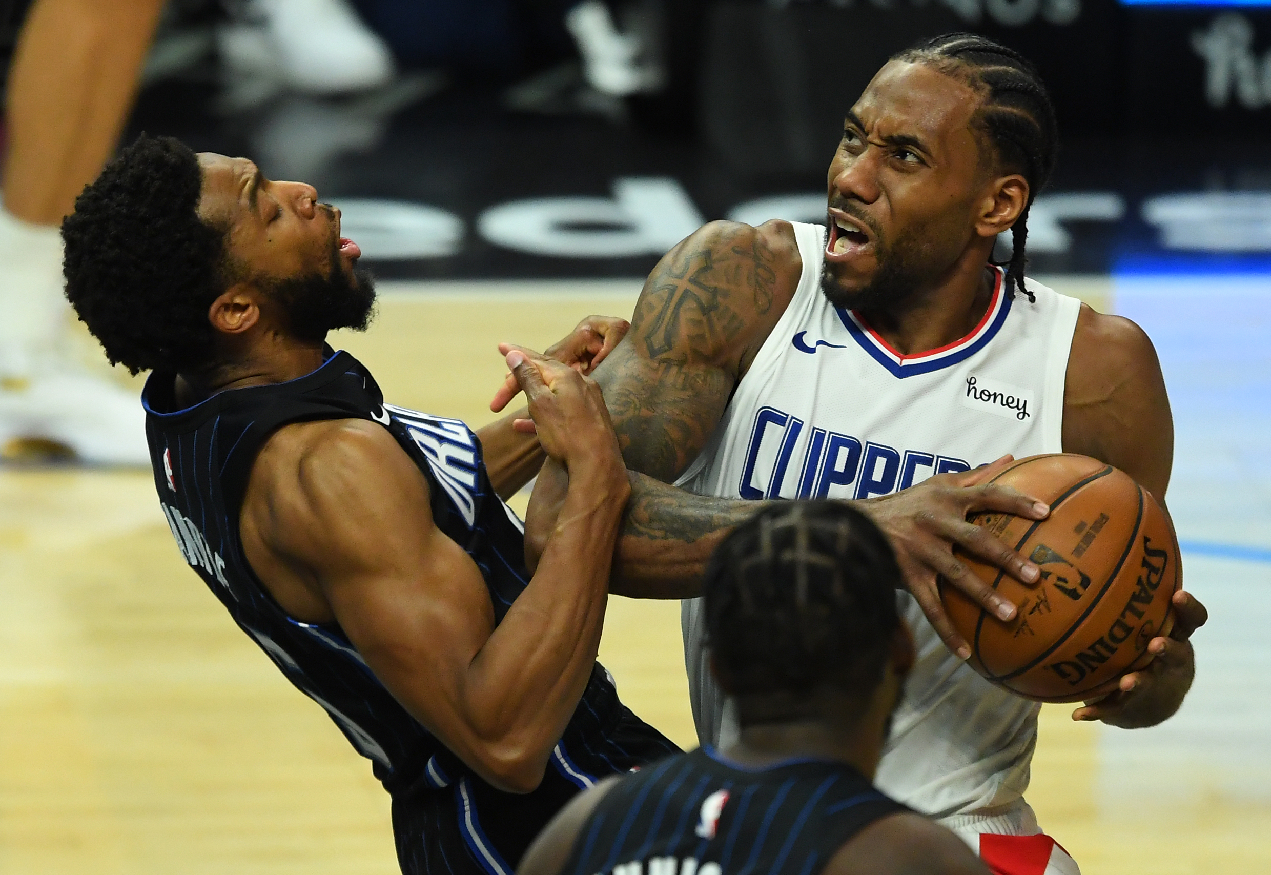 Mar 30, 2021; Los Angeles, California, USA; Los Angeles Clippers forward Kawhi Leonard (2) draws a foul from Orlando Magic guard Chasson Randle (25) as he drive to the basket during the second half at Staples Center. Mandatory Credit: Jayne Kamin-Oncea-USA TODAY Sports