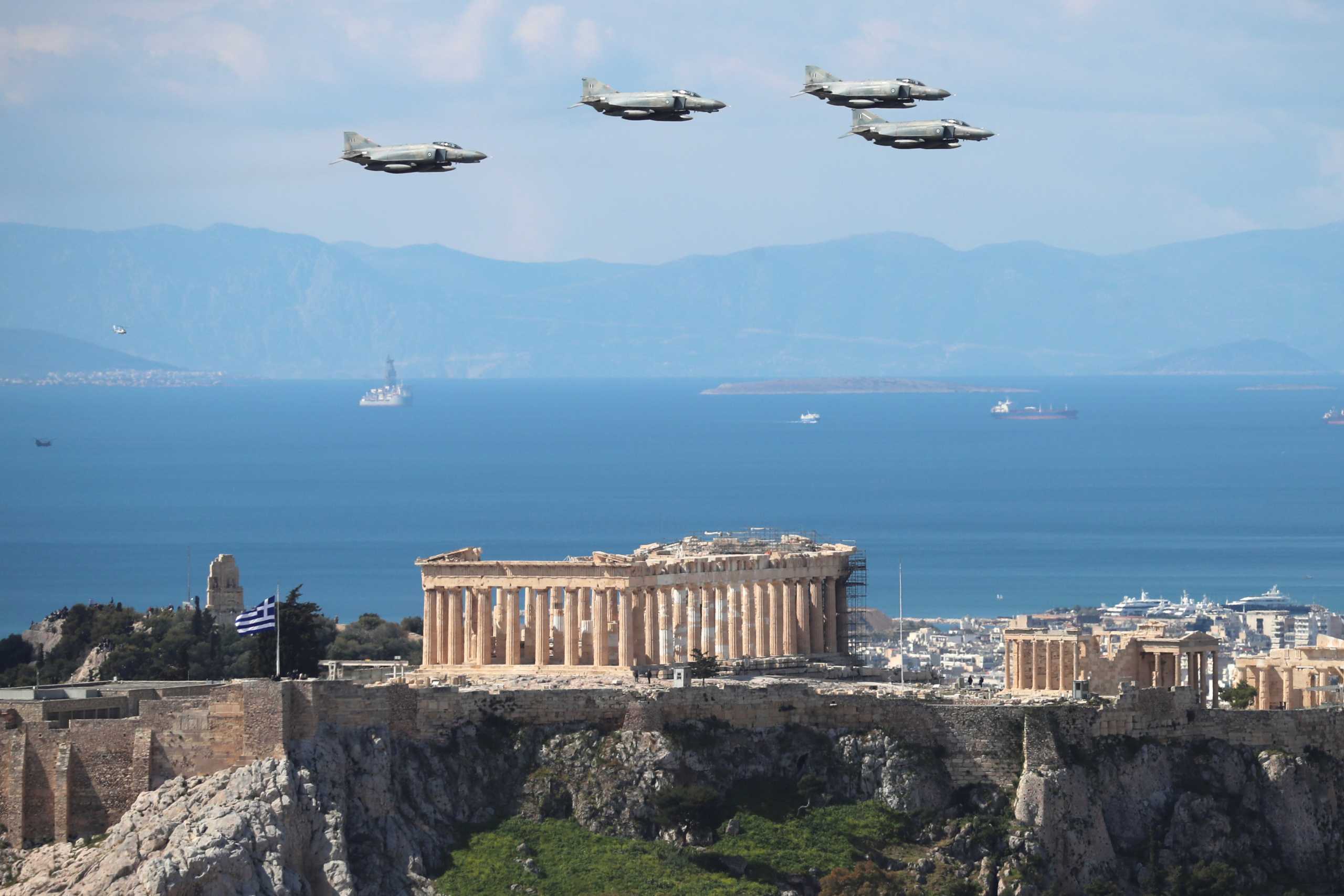 Military jets fly over the Parthenon during celebrations for the 200th anniversary of the Greek War of Independence in Athens, Greece March 25, 2021. REUTERS