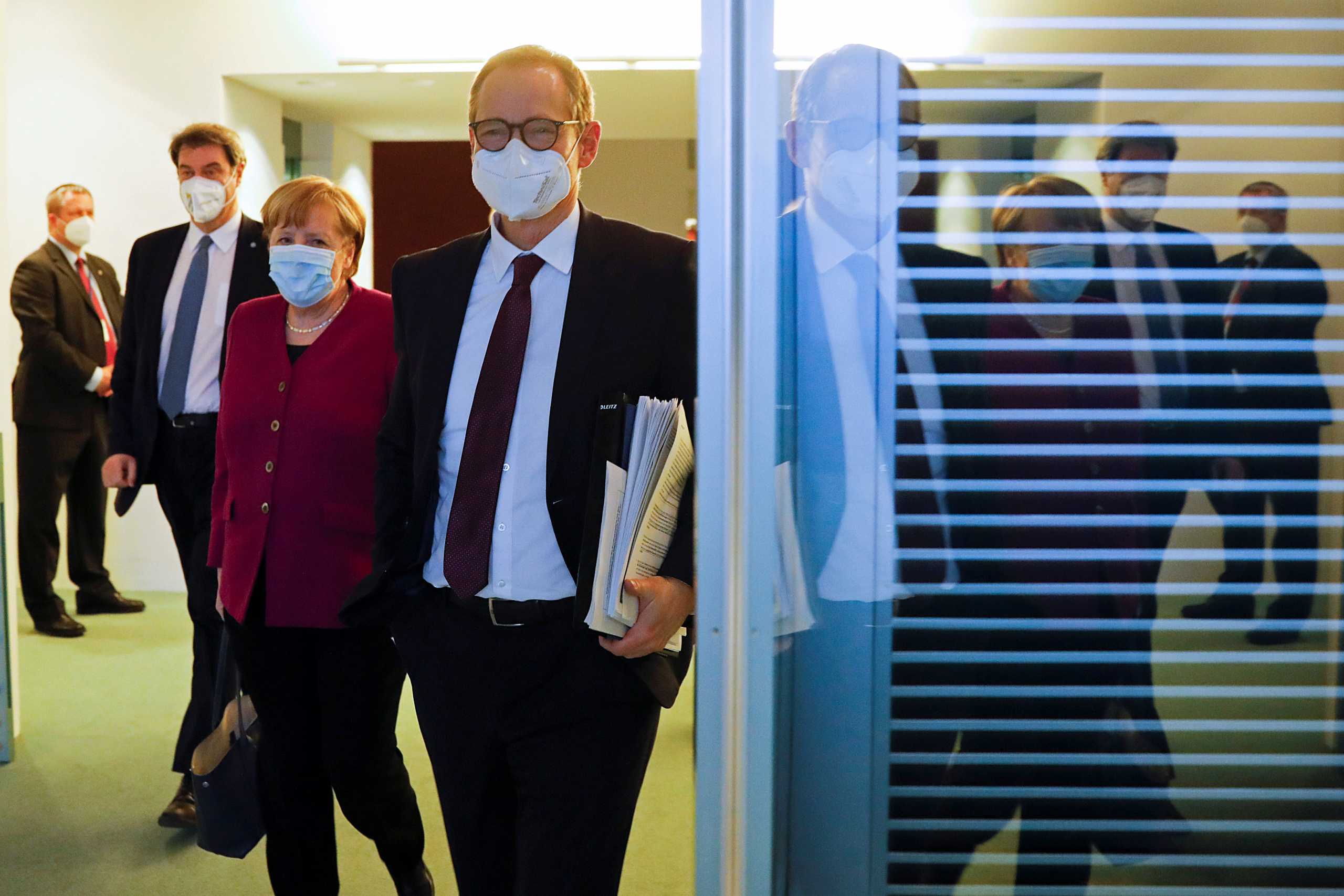 German Chancellor Angela Merkel, Bavarian State Governor Markus Soeder and the Mayor of Berlin Michael Mueller arrive for a news conference after a meeting with state leaders to discuss options beyond the end of the pandemic lockdown, amid the outbreak of the coronavirus disease (COVID-19), in Berlin, Germany, March 3, 2021. Markus Schreiber