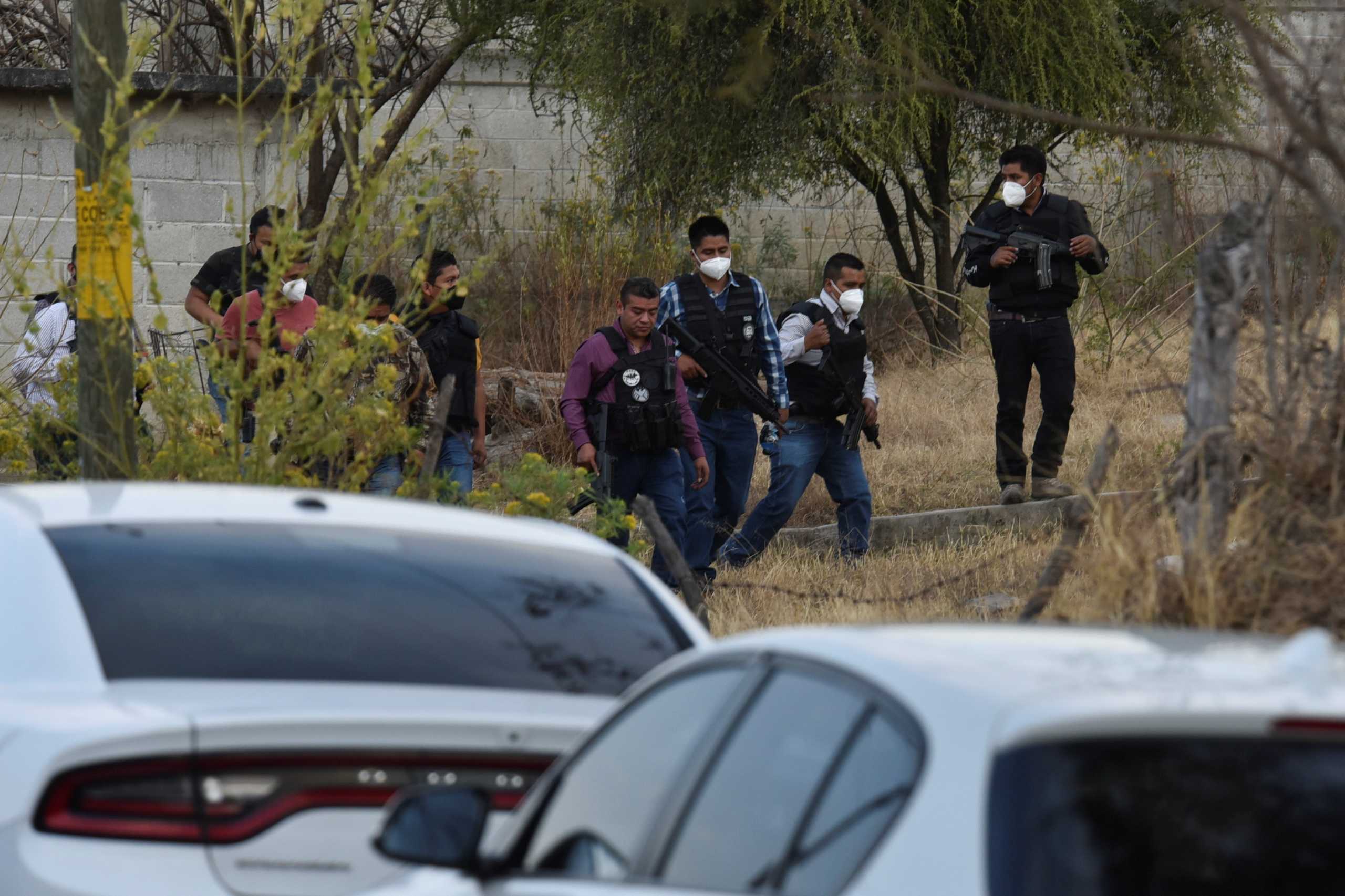 Police officers work at a crime scene where gunmen killed at least 13 Mexican police officers in an ambush, in Coatepec Harinas, Mexico March 18, 2021. REUTERS