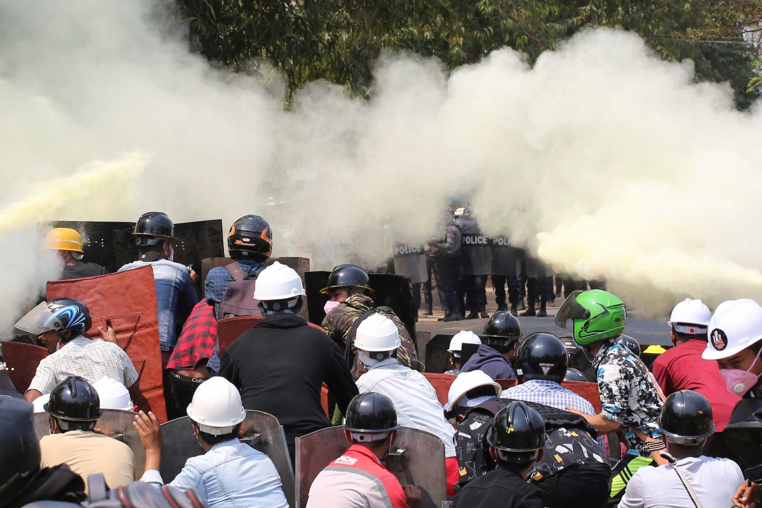 Tear gas and fire extinguisher gas float around demonstrators during a protest against the military coup in Naypyitaw, Myanmar, March 8, 2021. REUTERS
