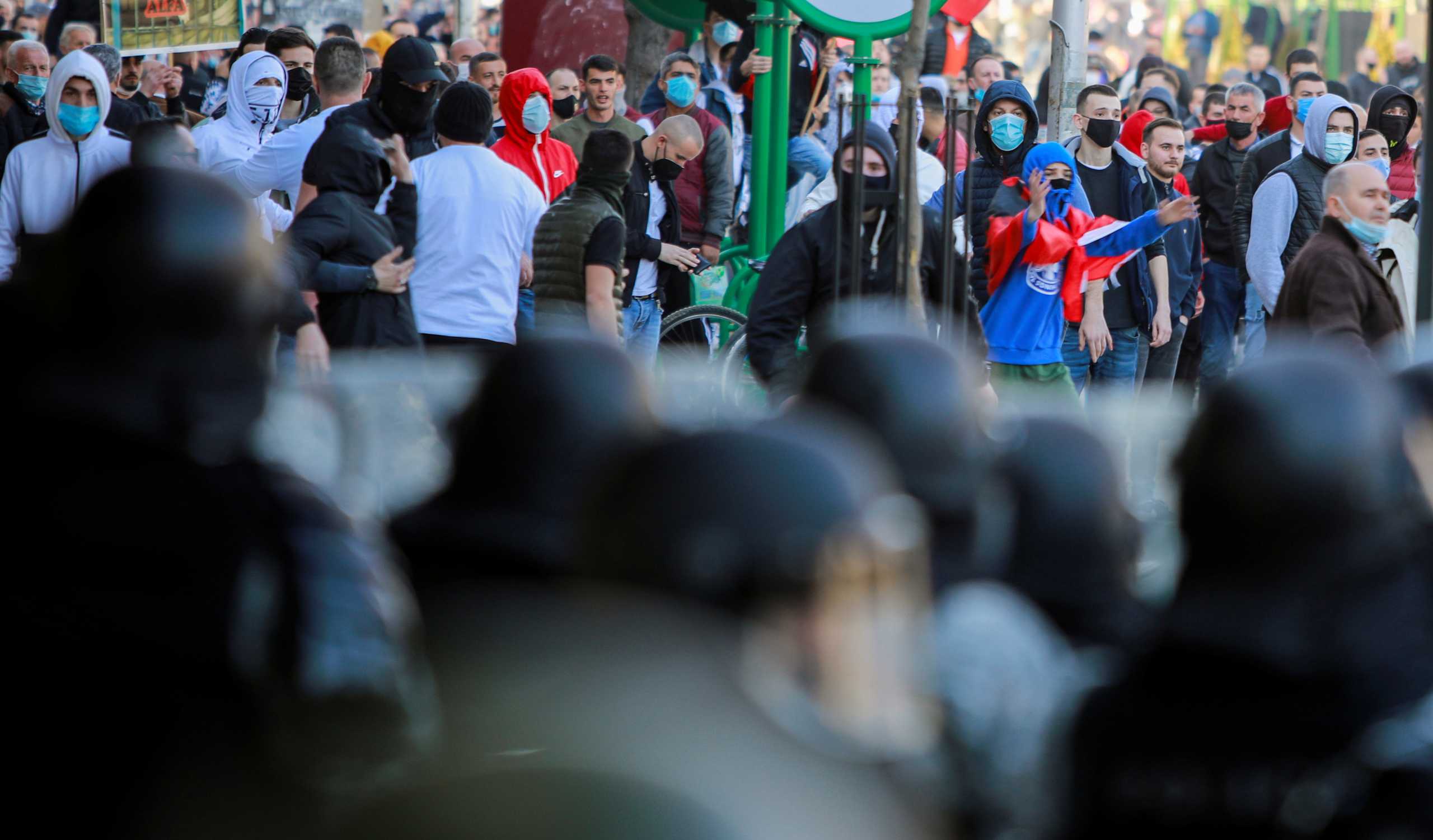 Men stand in front of police officers, as ethnic Albanians protest following a court decision in Skopje, North Macedonia, February 26, 2021. REUTERS