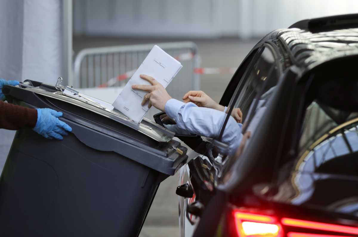 A person in a car votes at the RAI congress centre to limit the spread of the coronavirus disease (COVID-19), as the Dutch general election begins, in Amsterdam, Netherlands, March 15, 2021. REUTERS