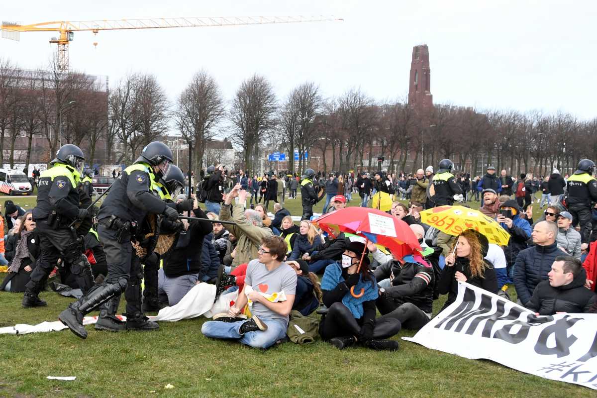 Police clash with demonstrators during a protest against coronavirus disease (COVID-19) restrictions in The Hague, Netherlands, March 14, 2021. REUTERS