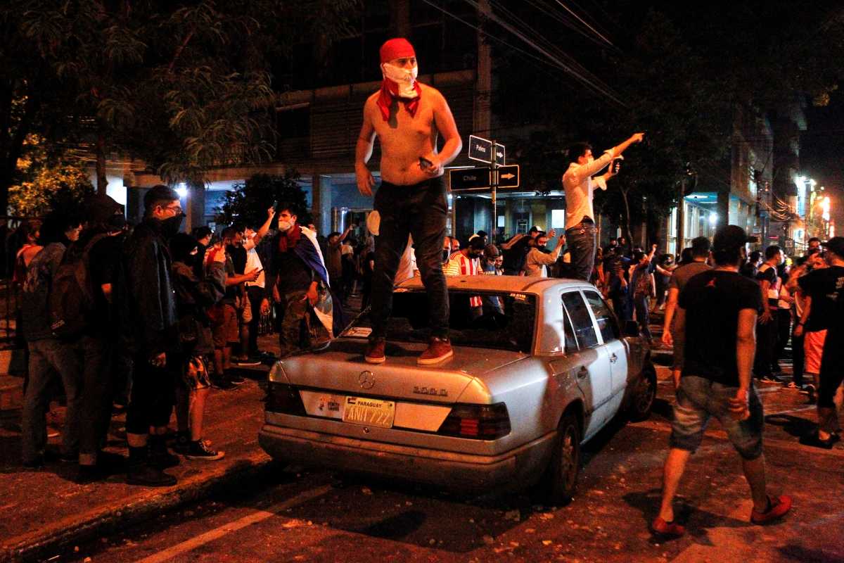 A demonstrator reacts on top of a car during a protest against President Mario Abdo Benitez's health policies and the lack of coronavirus disease (COVID-19) vaccines in Asuncion, Paraguay March 5, 2021. REUTERS
