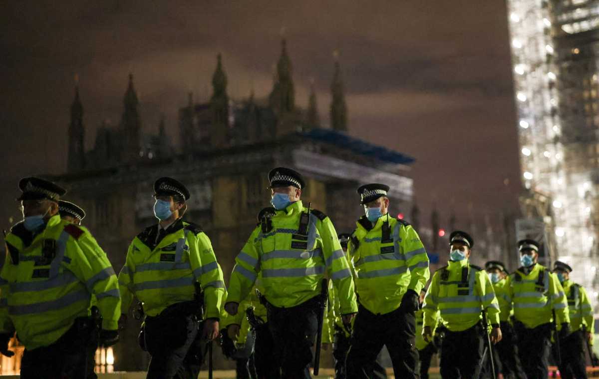 Police officers cross Westminster Bridge during a protest, following the kidnap and murder of Sarah Everard, in London, Britain March 15, 2021. REUTERS