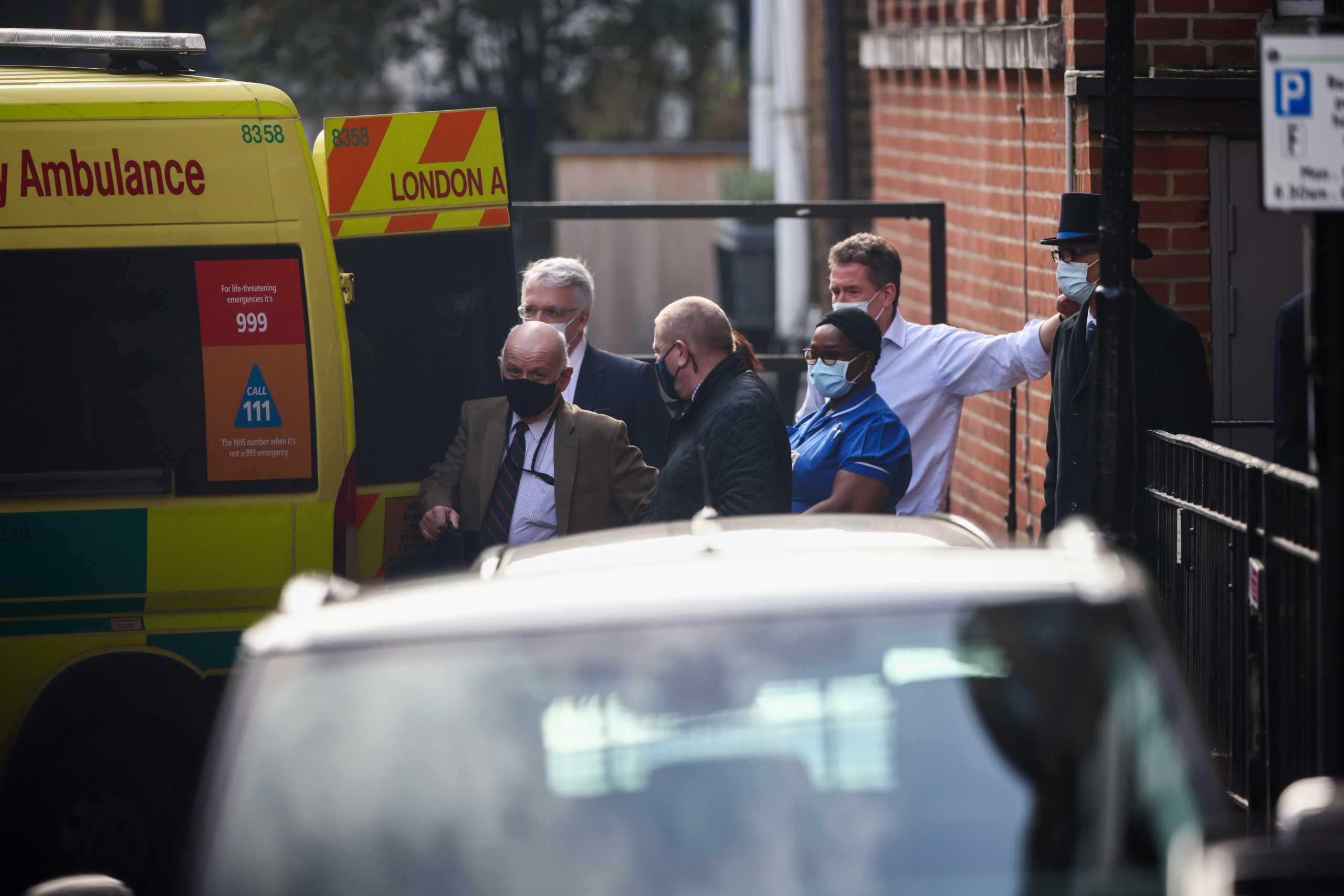 Hospital staff stand next to an ambulance outside King Edward VII's Hospital, where Britain's Prince Philip was admitted in London, Britain, March 1, 2021. REUTERS