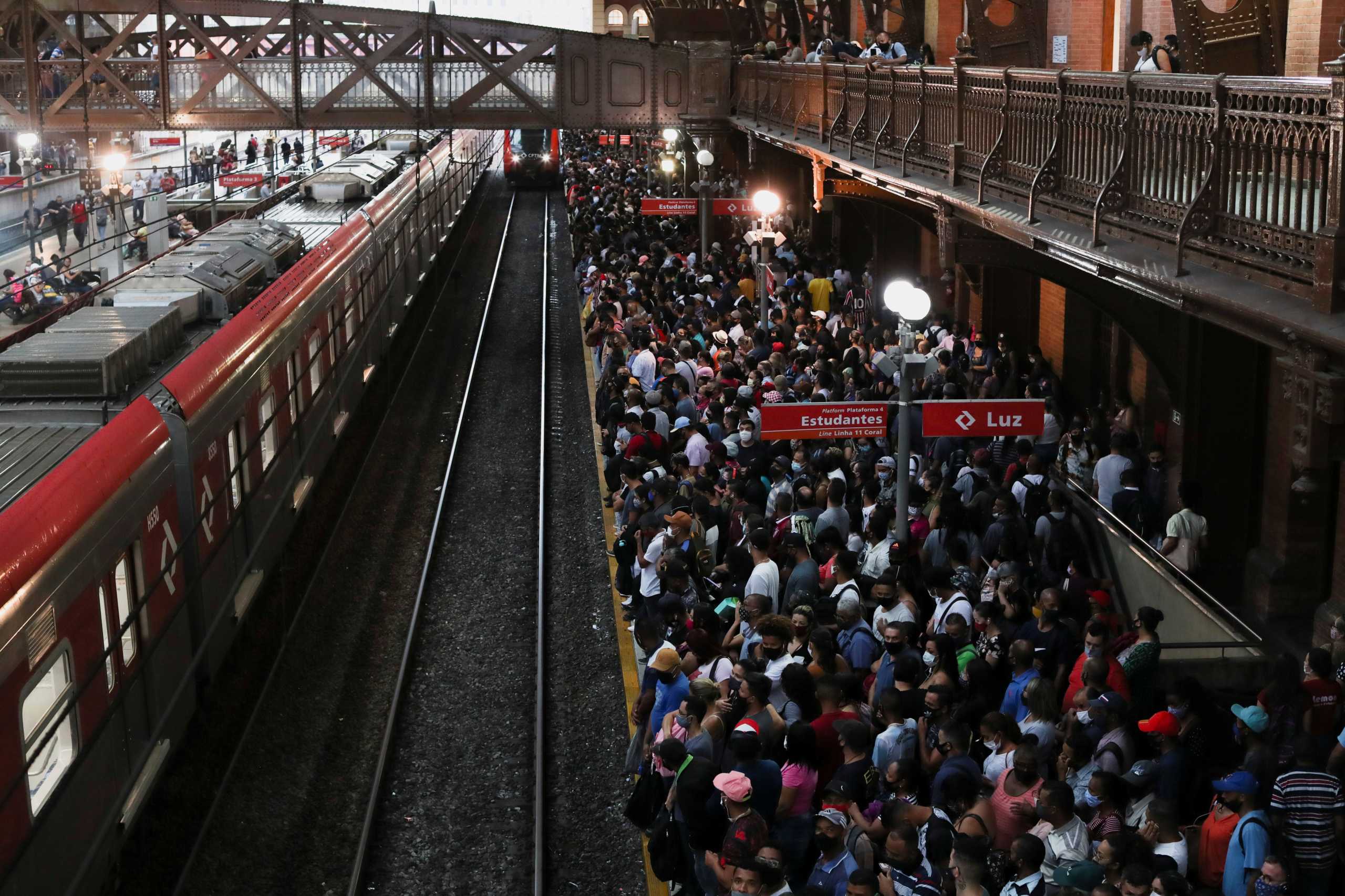 People gather to board a train at Luz station during the outbreak of the coronavirus disease (COVID-19) in Sao Paulo, Brazil March 4, 2021. REUTERS