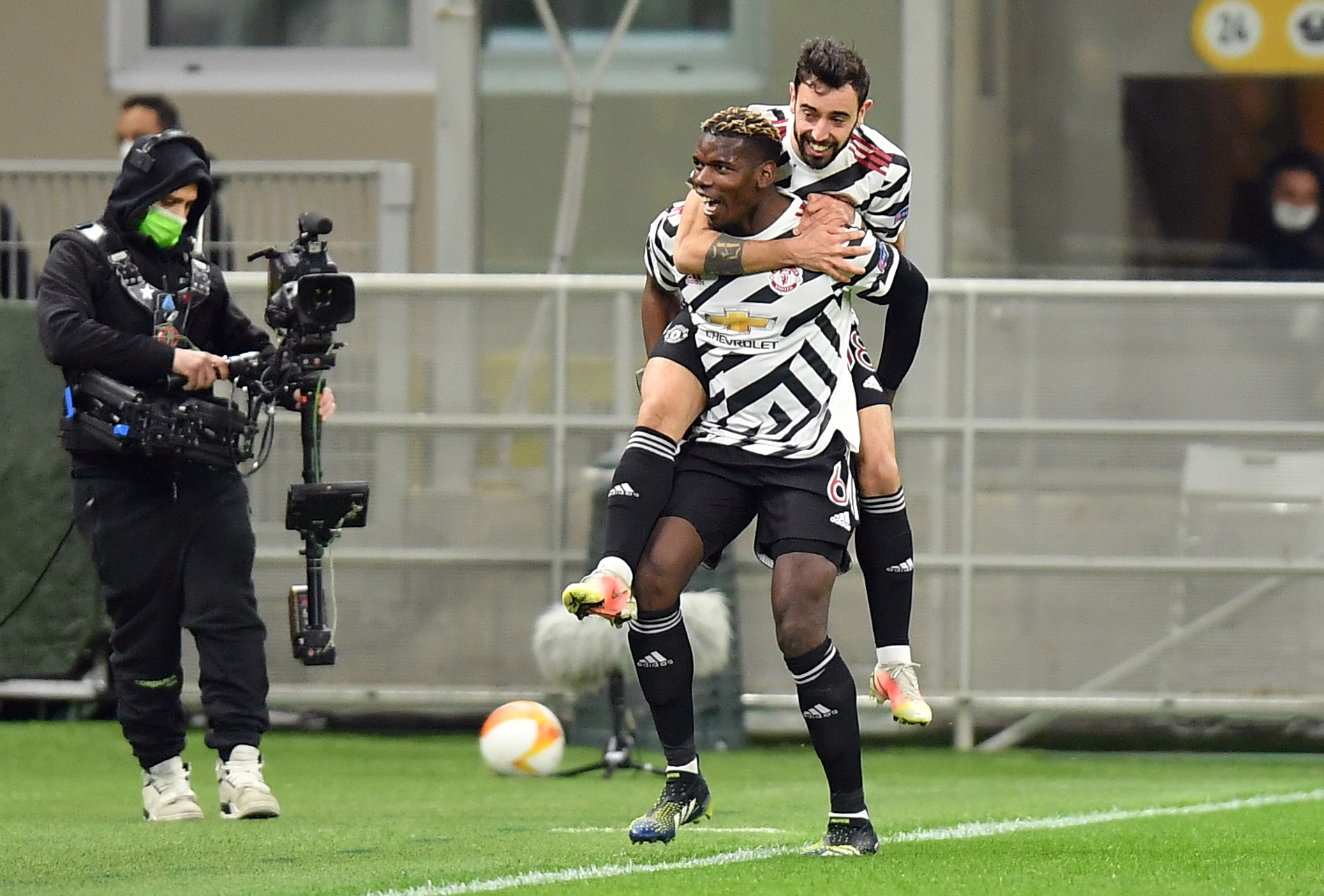 Soccer Football - Europa League - Round of 16 Second Leg - AC Milan v Manchester United - San Siro, Milan, Italy - March 18, 2021 Manchester United's Paul Pogba celebrates scoring their first goal with Bruno Fernandes REUTERS